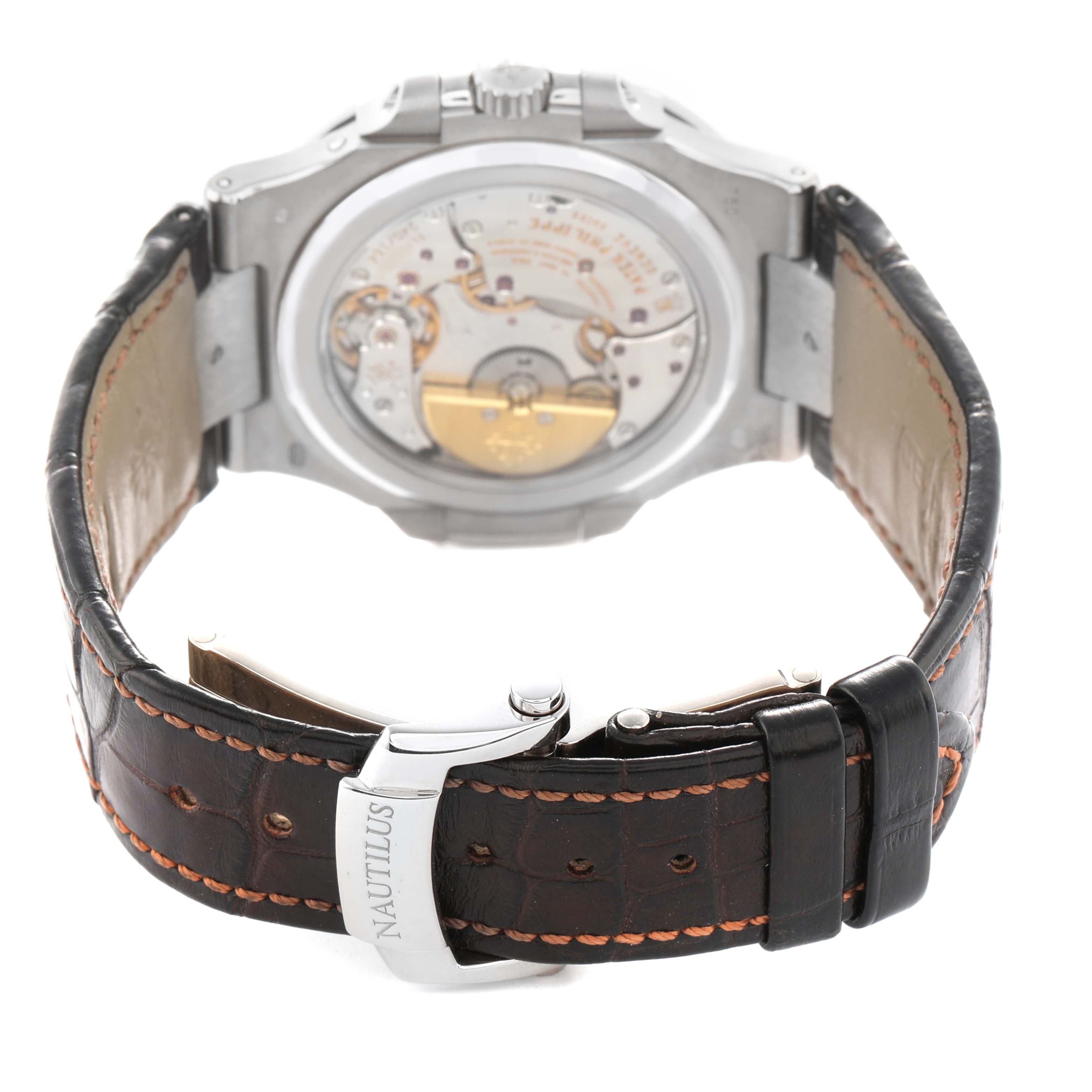 The image shows the back of a Patek Philippe Nautilus 5712G-001 Men's White Gold Grey Dial watch displaying its movement and leather strap with clasp.