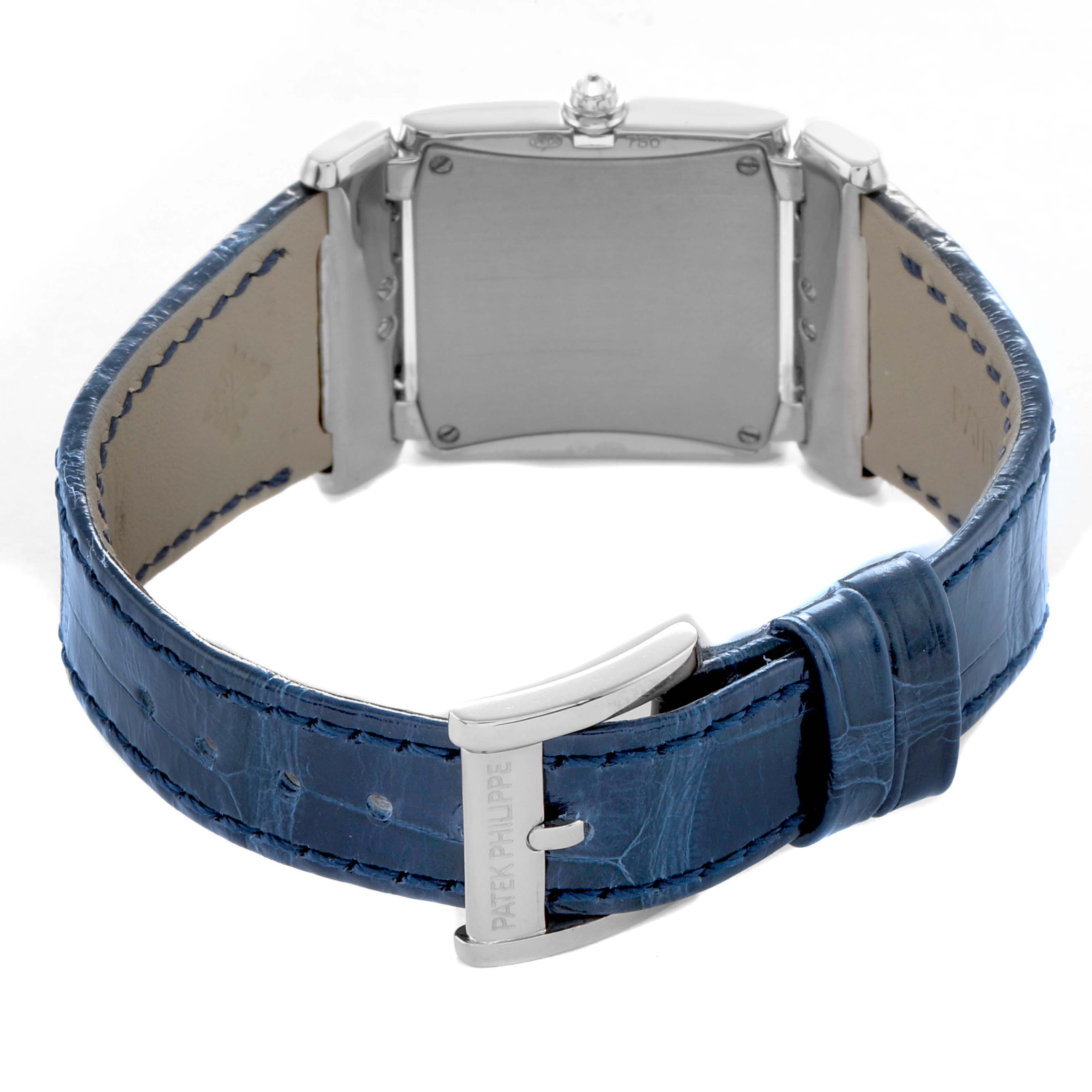 The image shows the back of a Patek Philippe Twenty-4 4920G-010 Women's White Gold Silver Dial watch with a blue strap and visible buckle and case back.