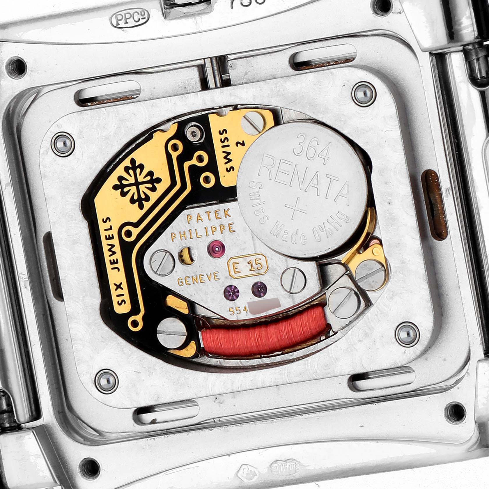 The image shows the movement of the Patek Philippe Twenty-4 4920G-010 Women's White Gold Silver Dial watch, highlighting the battery and internal components.