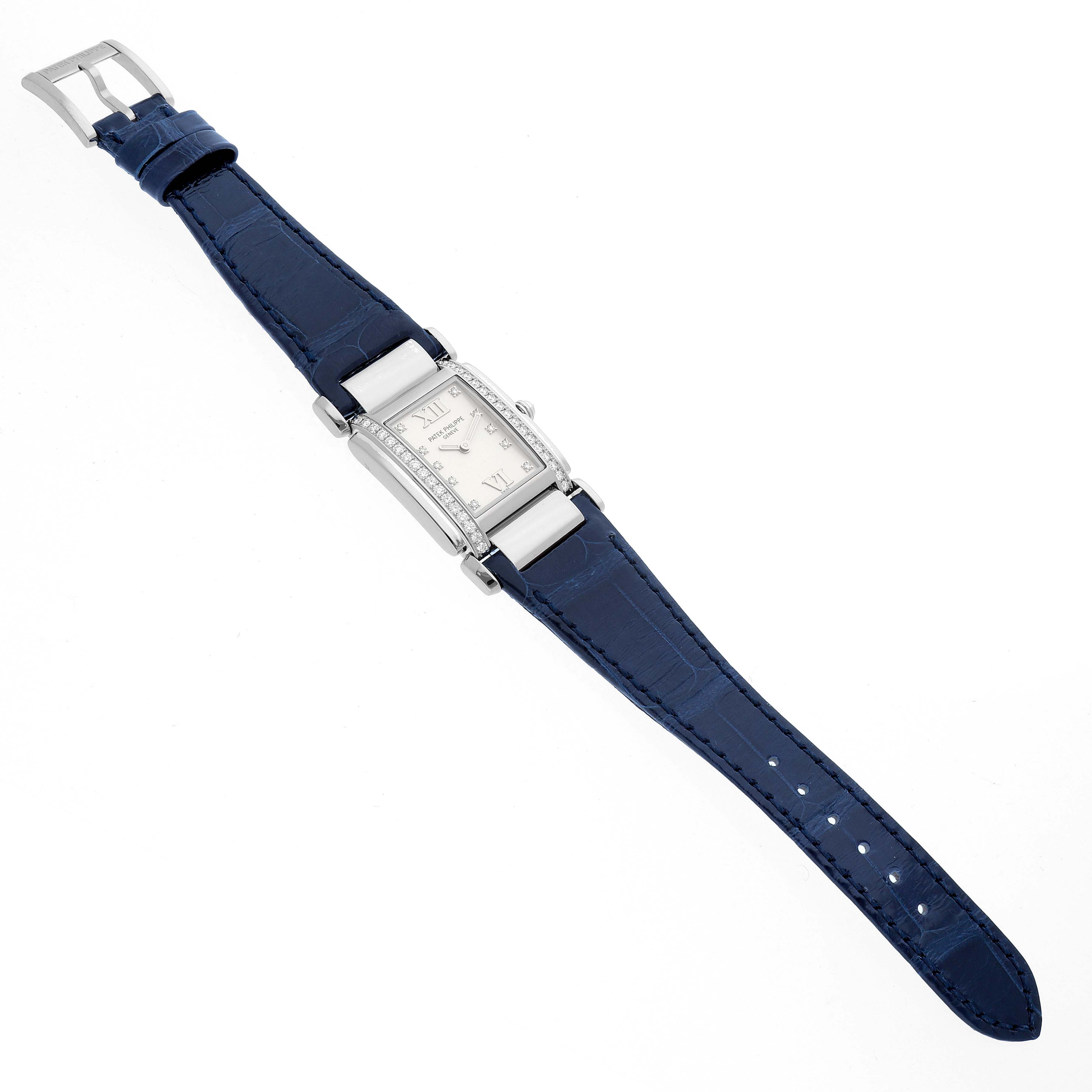 The Patek Philippe Twenty-4 4920G-010 Women's White Gold Silver Dial watch is shown from a top-down angle, displaying the face, case, and blue strap.