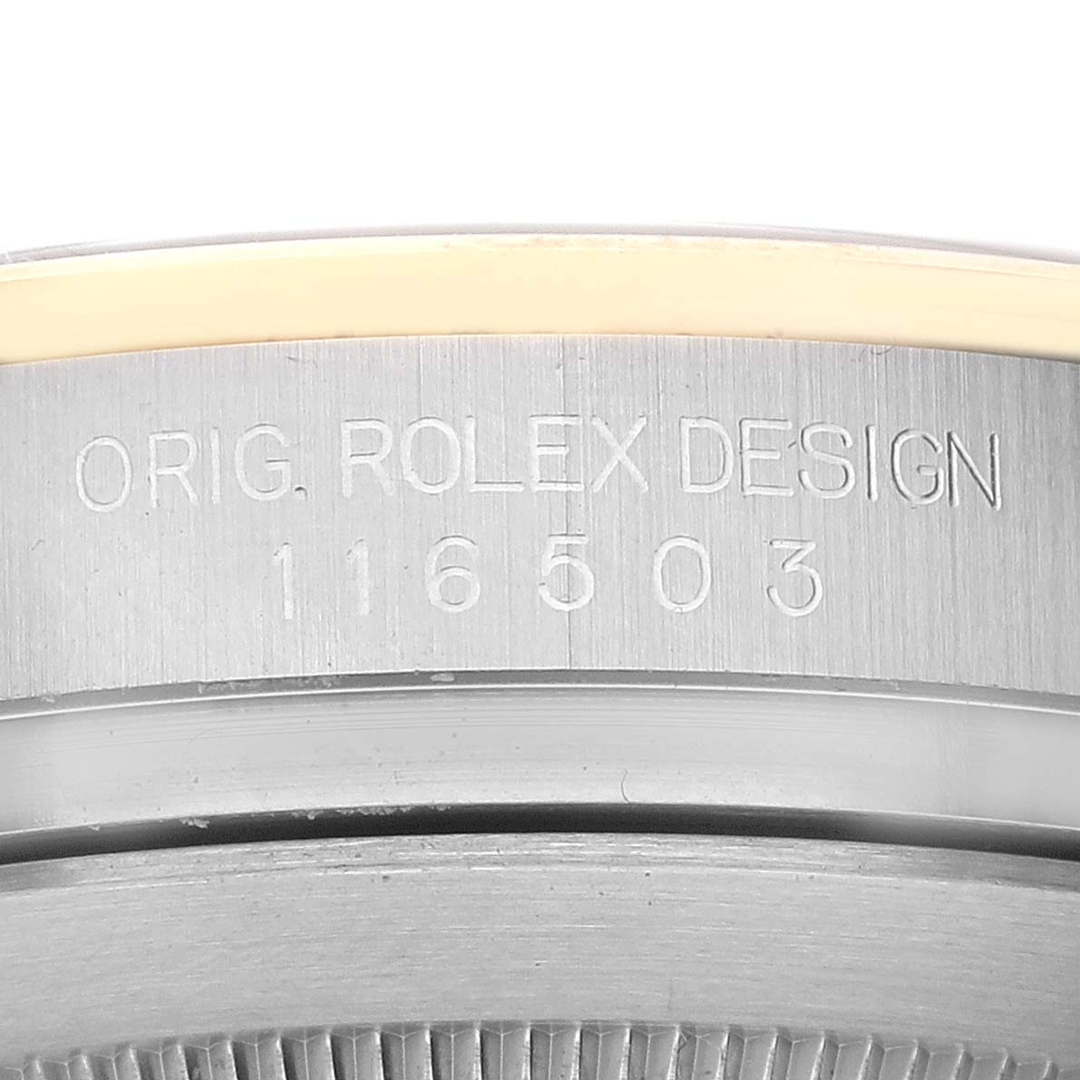 The image shows a close-up of the side of a Rolex Daytona 116503 Men's Steel and Gold (two tone) Black Dial 116503 Men's Steel and Gold (two tone) Black Dial watch case, revealing the "ORIG. ROLEX DESIGN" engraving and model number 116503.