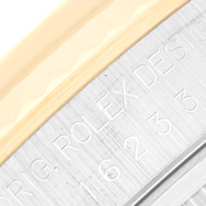 The image shows a close-up of the Rolex Datejust 16233 Men's Steel and Gold (two tone) Champagne Dial 16233 Men's Steel and Gold (two tone) Champagne Dial watch, highlighting the engraved text on the metal case edge.