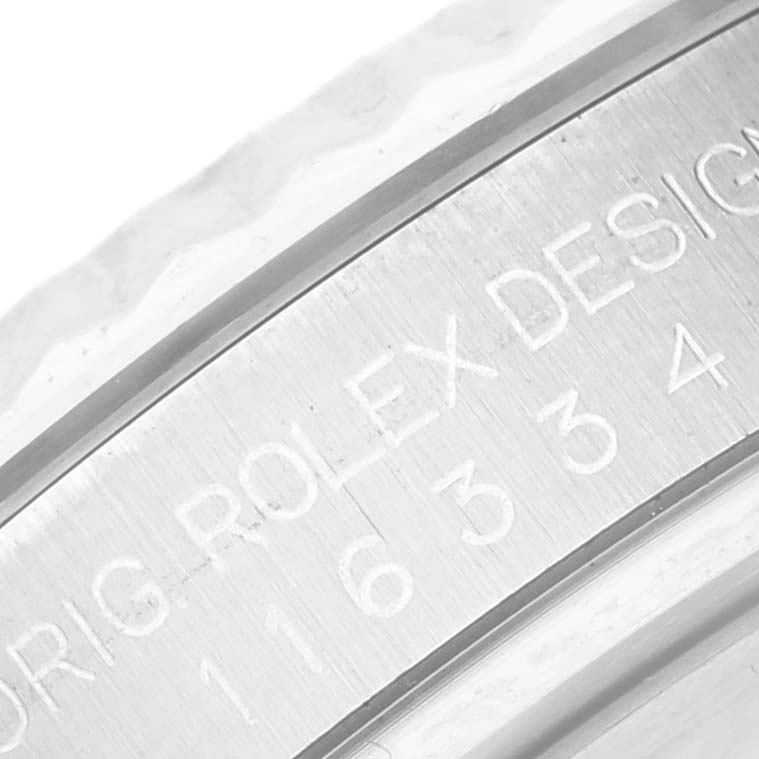 This close-up image shows the engraved serial number on the inner bezel of a Rolex Datejust 41 116334 Men
s Stainless Steel Blue Dial 116334 Men
s Stainless Steel Blue Dial watch.