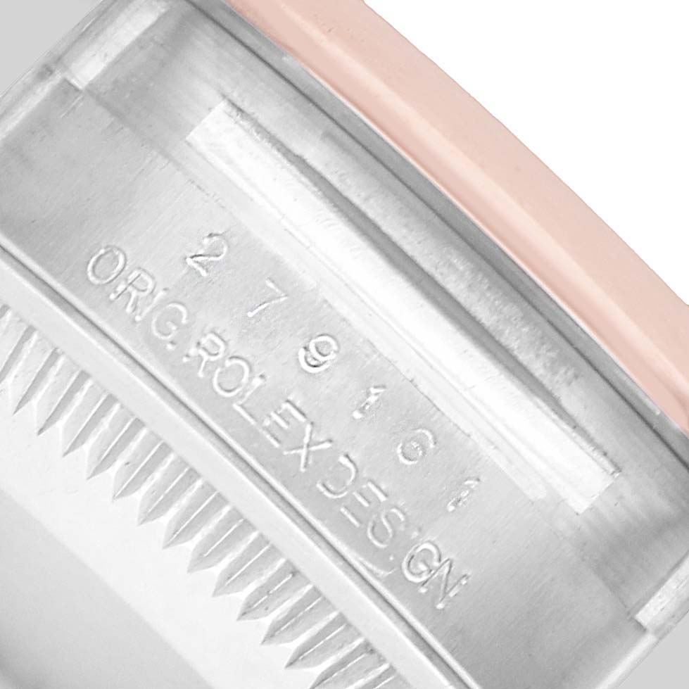 The image shows a close-up of the side of a Rolex Datejust 279161 Women's Steel and Gold (two tone) Silver Dial, featuring the serial number and "ORG ROLEX DESIGN" engraving on the metal.