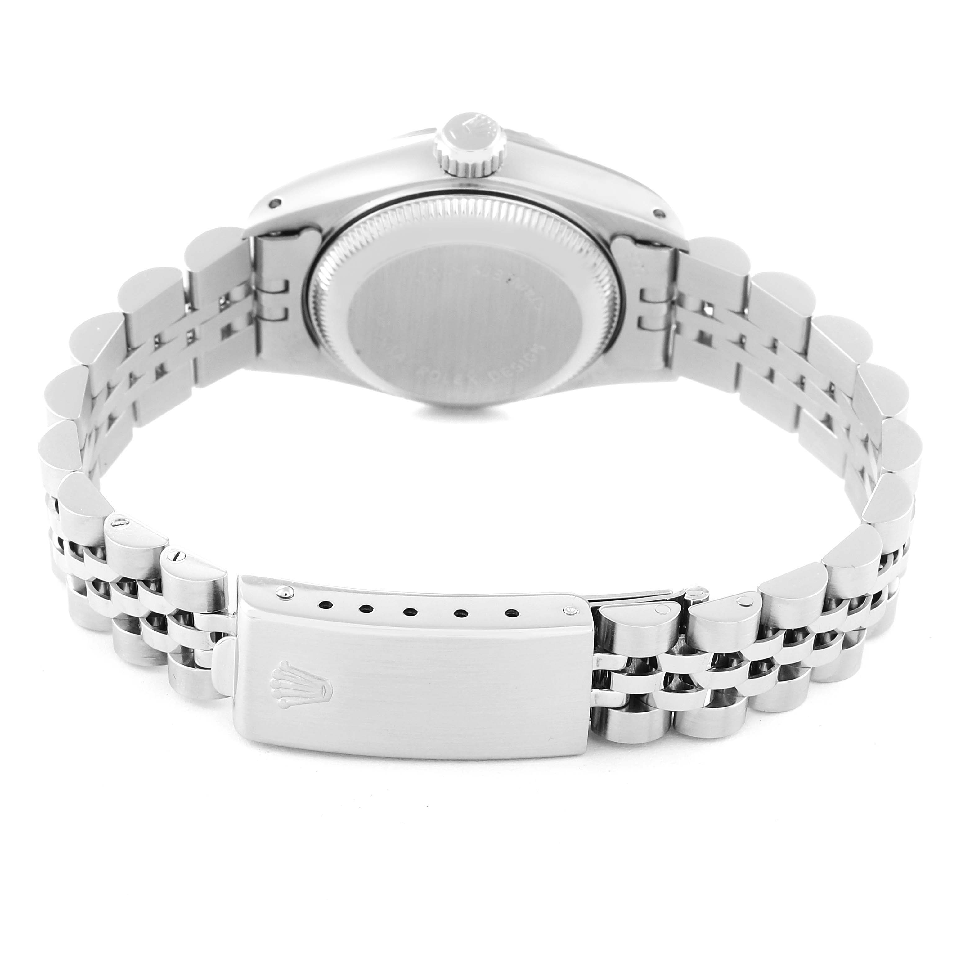 The image shows the rear view of a Rolex Datejust 69174 Women's Stainless Steel Black Dial 69174 Women's Stainless Steel Black Dial watch, featuring its case back, crown, and metal bracelet with clasp.