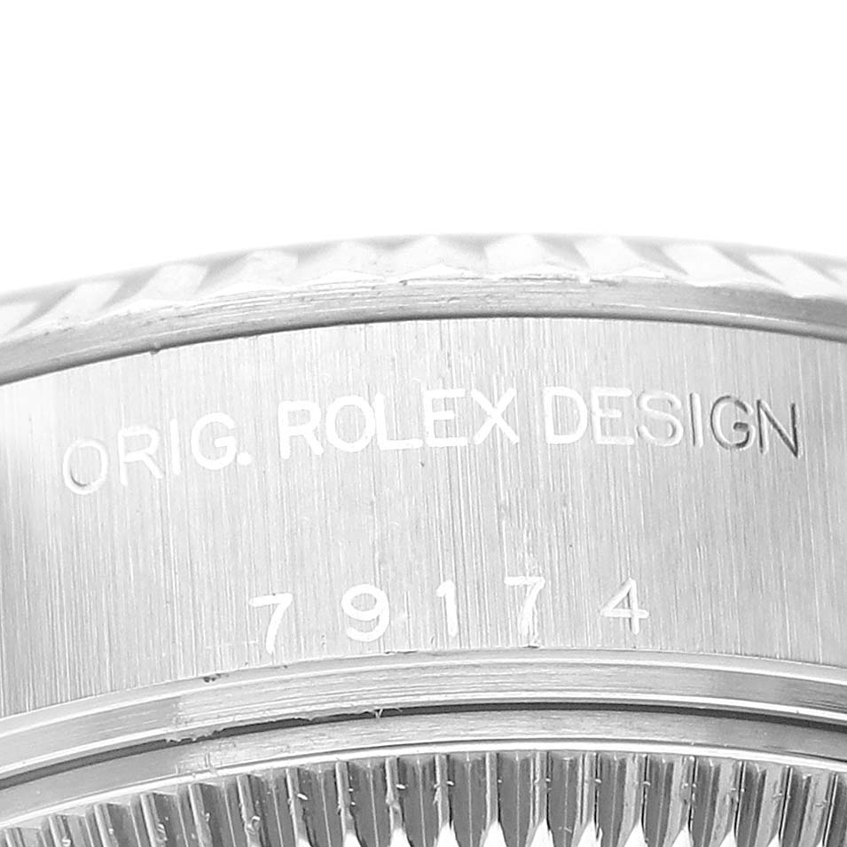This image shows a close-up of the side engraving on the bezel of a Rolex Datejust 79174 Women's Stainless Steel Silver Dial 79174 Women's Stainless Steel Silver Dial watch with the text "ORIG. ROLEX DESIGN" and model number "79174".