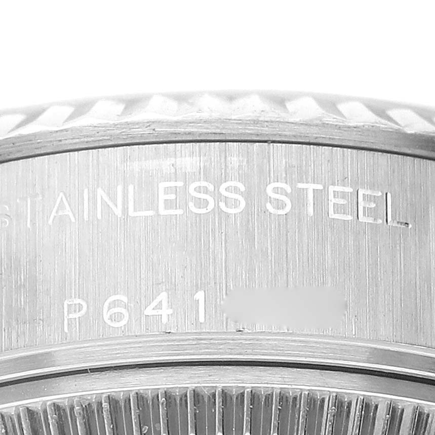 This is a close-up shot of the stainless steel case of a Rolex Datejust 79174 Women's Stainless Steel Silver Dial 79174 Women's Stainless Steel Silver Dial watch, showing part of its bezel and engraved details.