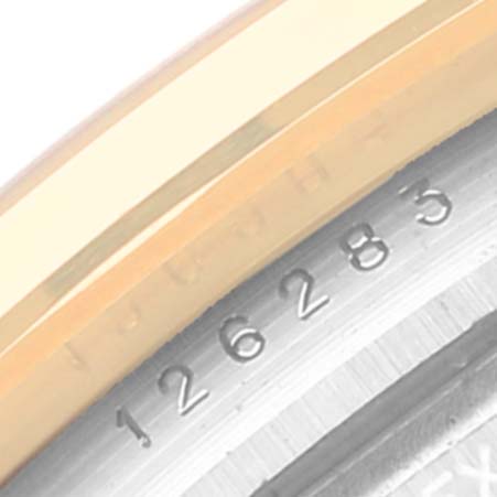 This image shows a close-up angle of the serial number engraving and part of the bezel on a Rolex Datejust 126283 Men's Steel and Gold (two tone) Silver Dial 126283 Men's Steel and Gold (two tone) Silver Dial watch.