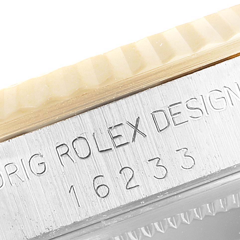 The image shows a close-up of the engraved case side of a Rolex Datejust 16233 Men's Steel and Gold (two tone) Silver Dial 16233 Men's Steel and Gold (two tone) Silver Dial watch, including the model number 16233.