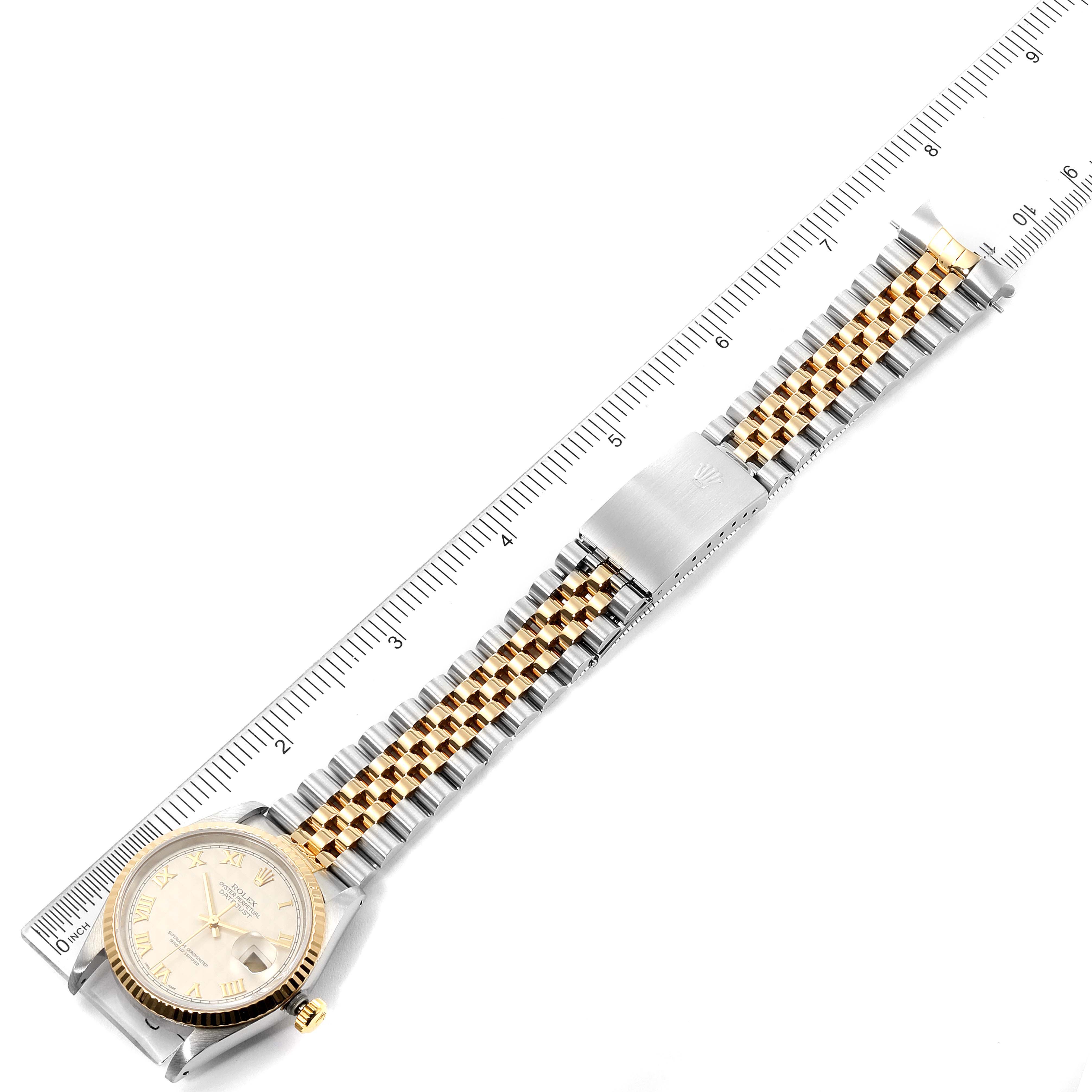 The Rolex Datejust 16233 Men's Steel and Gold (two tone) Silver Dial 16233 Men's Steel and Gold (two tone) Silver Dial watch is shown from a top view, including the case, bracelet, clasp, and a measuring scale.