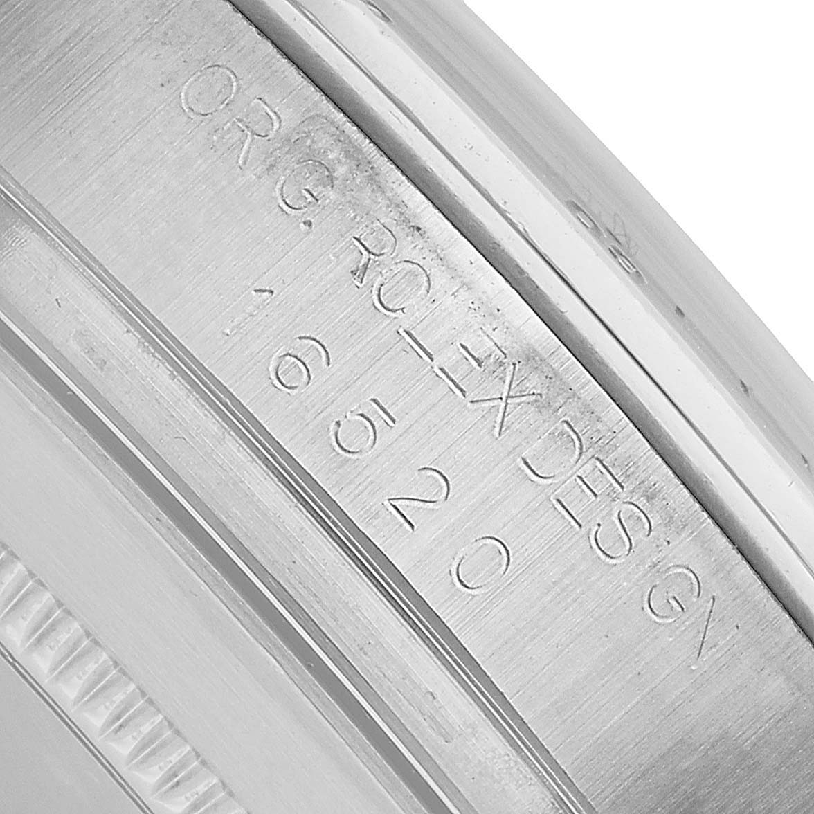 The image shows a close-up of the engraved side of the Rolex Daytona 16520 Men's Stainless Steel White Dial watch case, focusing on the model number and branding.