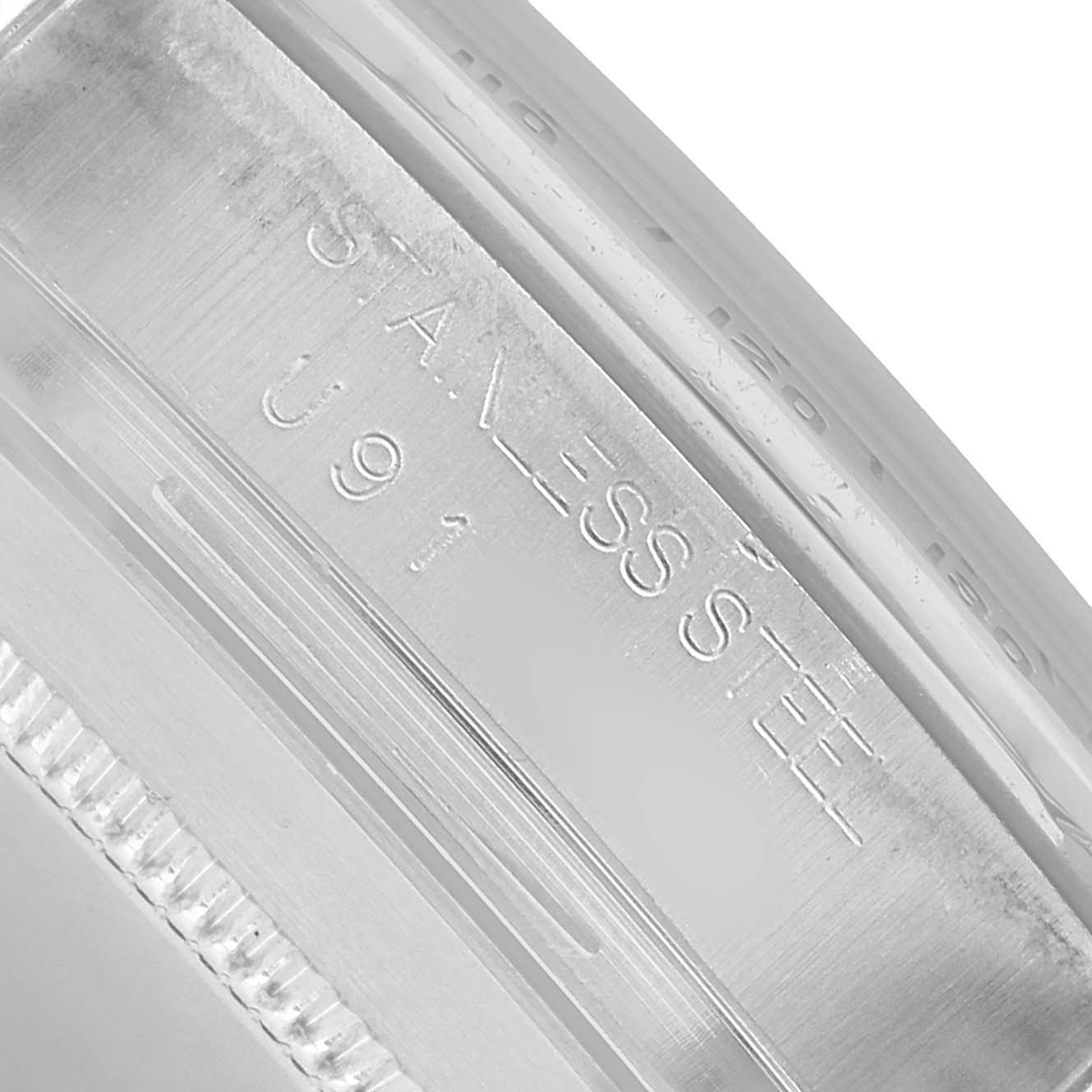 The image shows a close-up of the Rolex Daytona 16520 Men's Stainless Steel White Dial's case edge with "STAINLESS STEEL" engraved.