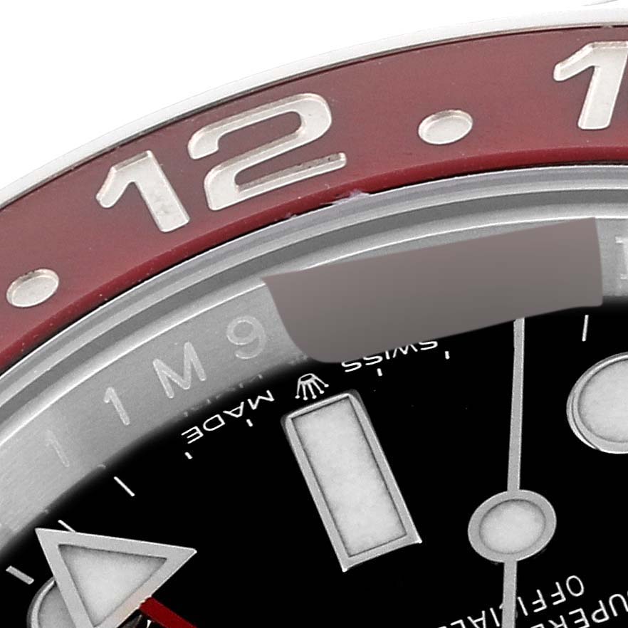 This close-up image of the Rolex GMT-Master 126710 Men
s Stainless Steel Black Dial 126710 Men
s Stainless Steel Black Dial watch shows the bezel, part of the dial, and hour markers.