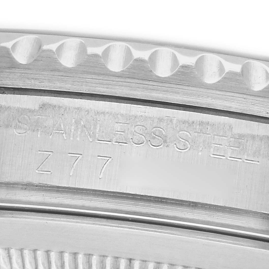 The image shows a close-up of the side of a Rolex GMT-Master 16710 Men's Stainless Steel Black Dial, highlighting the stainless steel case with engraved text.