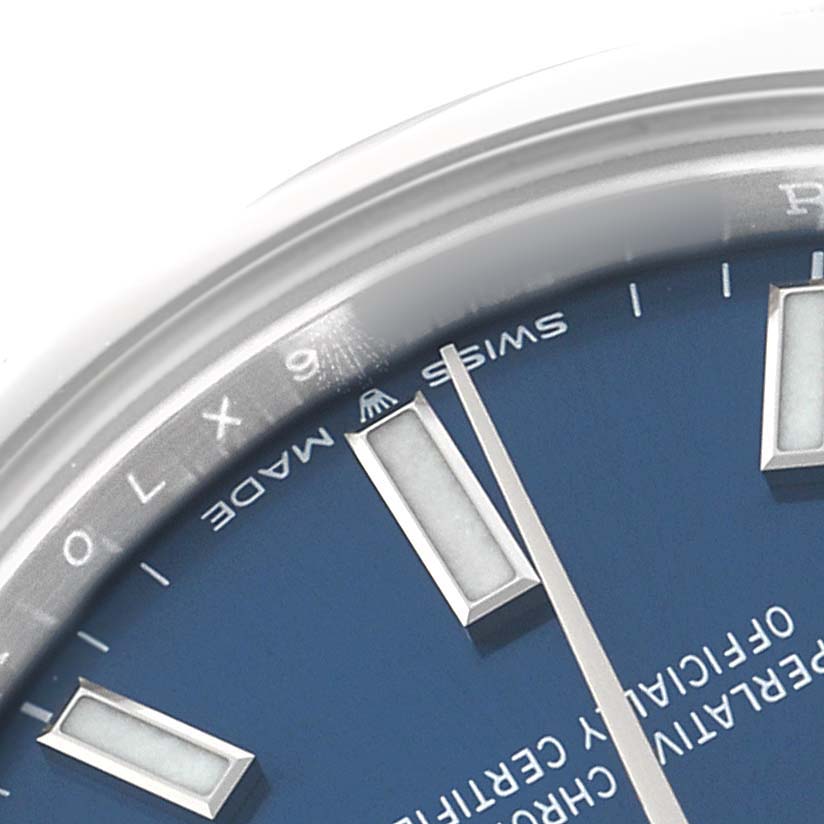 The image shows a close-up of the Rolex Mid-Size 277200 Women's Stainless Steel Blue Dial watch dial, highlighting the hour markers, hands, and part of the chapter ring.