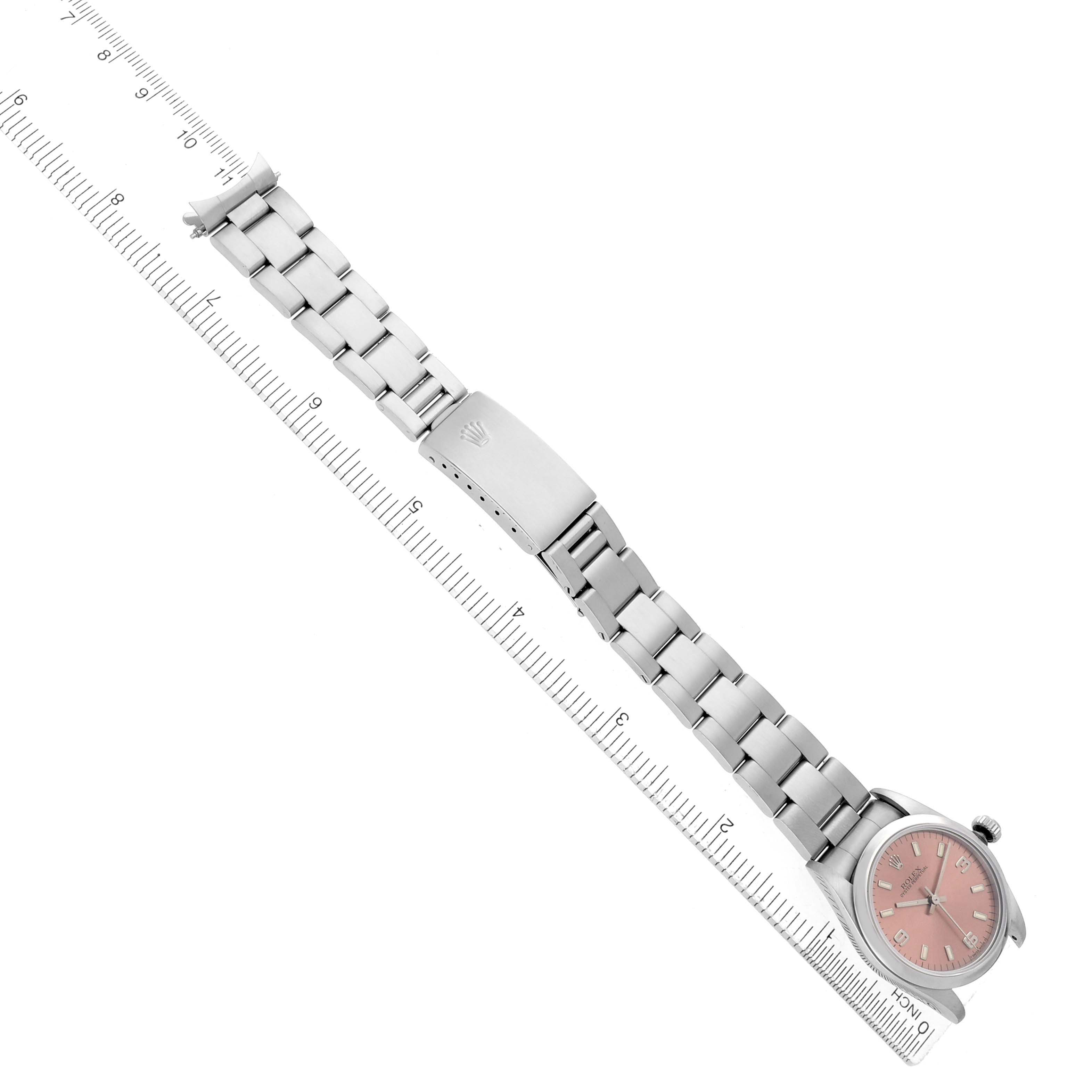 The Rolex Oyster Perpetual 67480 Women's Stainless Steel Pink Dial watch is shown at an angled top view, displaying the bracelet, clasp, and pink dial.