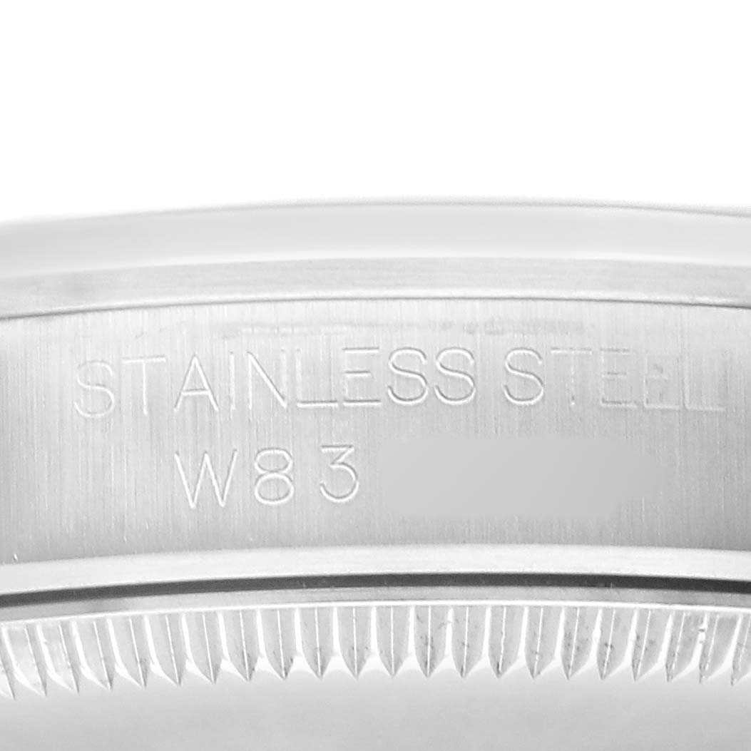 This image shows a close-up of the back side of the Rolex Oyster Perpetual 67480 Women's Stainless Steel Pink Dial, highlighting the stainless steel edge and engravings.