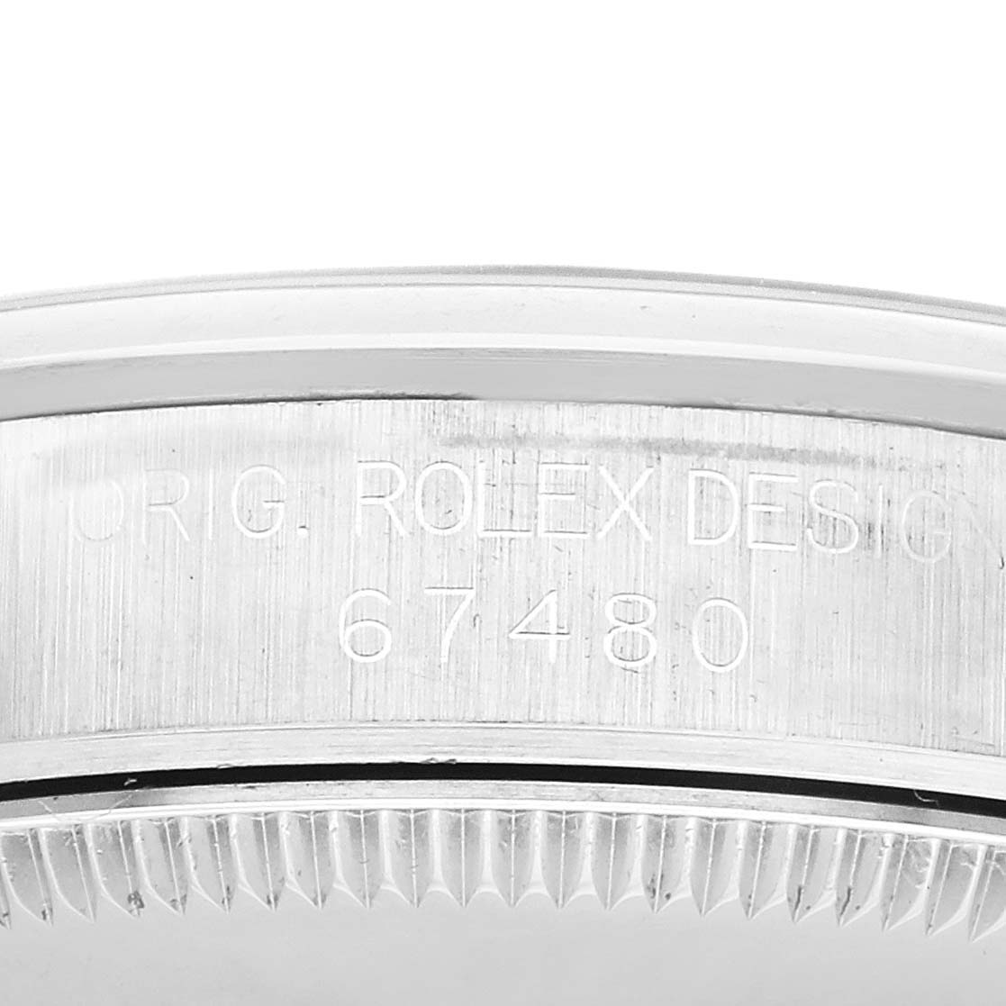 The image shows the side view of the bezel and case edge with engravings on the Rolex Oyster Perpetual 67480 Women's Stainless Steel Pink Dial watch.