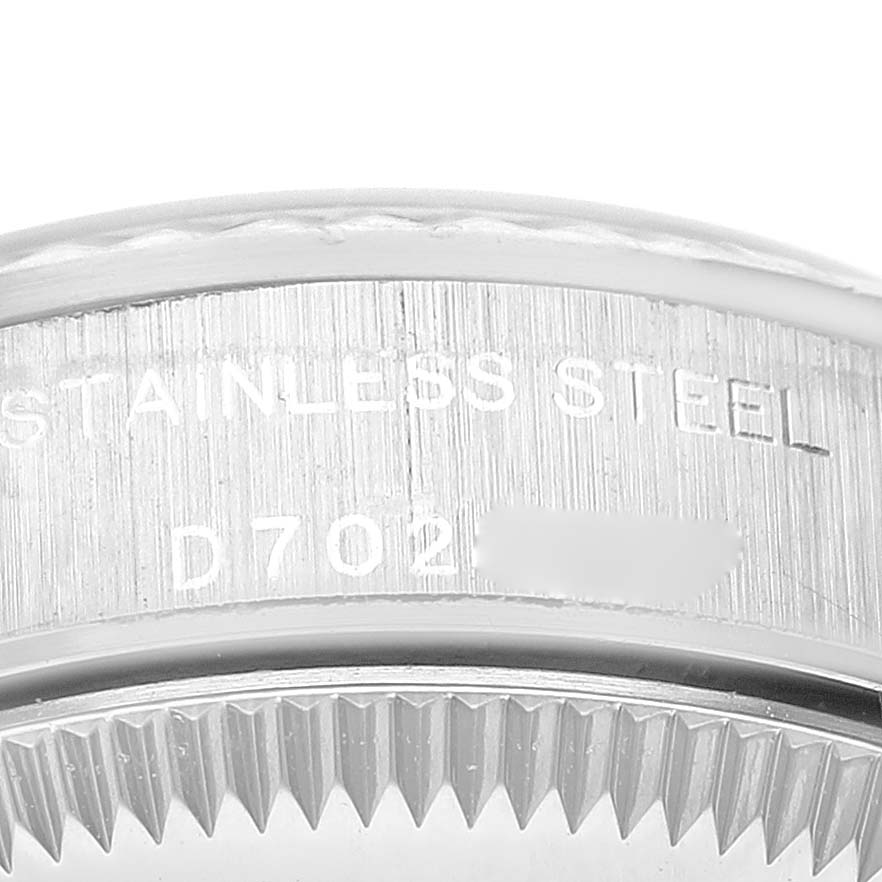 The image shows a close-up view of the stainless steel case back and serial number of a Rolex Oyster Perpetual 76094 Women
s Stainless Steel Pink Dial 76094 Women
s Stainless Steel Pink Dial watch.