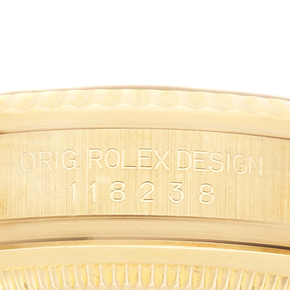 The image shows the side of a Rolex President 118238 Men's Yellow Gold Champagne Dial watch, featuring its case with engraved model details.
