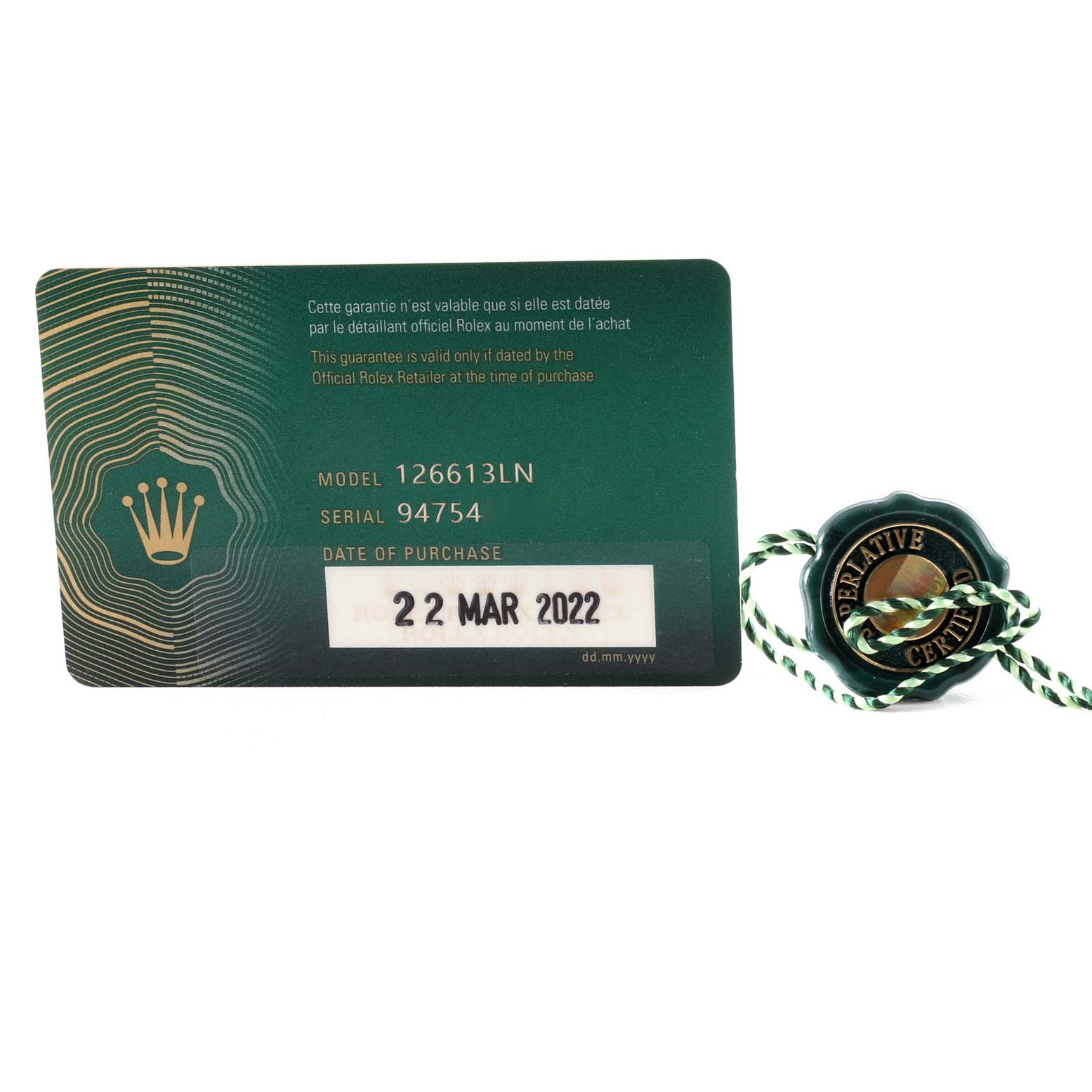 The image shows a warranty card and a certification tag for the Rolex Submariner 126613LN Men
s Steel and Gold (two tone) Black Dial 126613LN Men
s Steel and Gold (two tone) Black Dial model 126613LN.