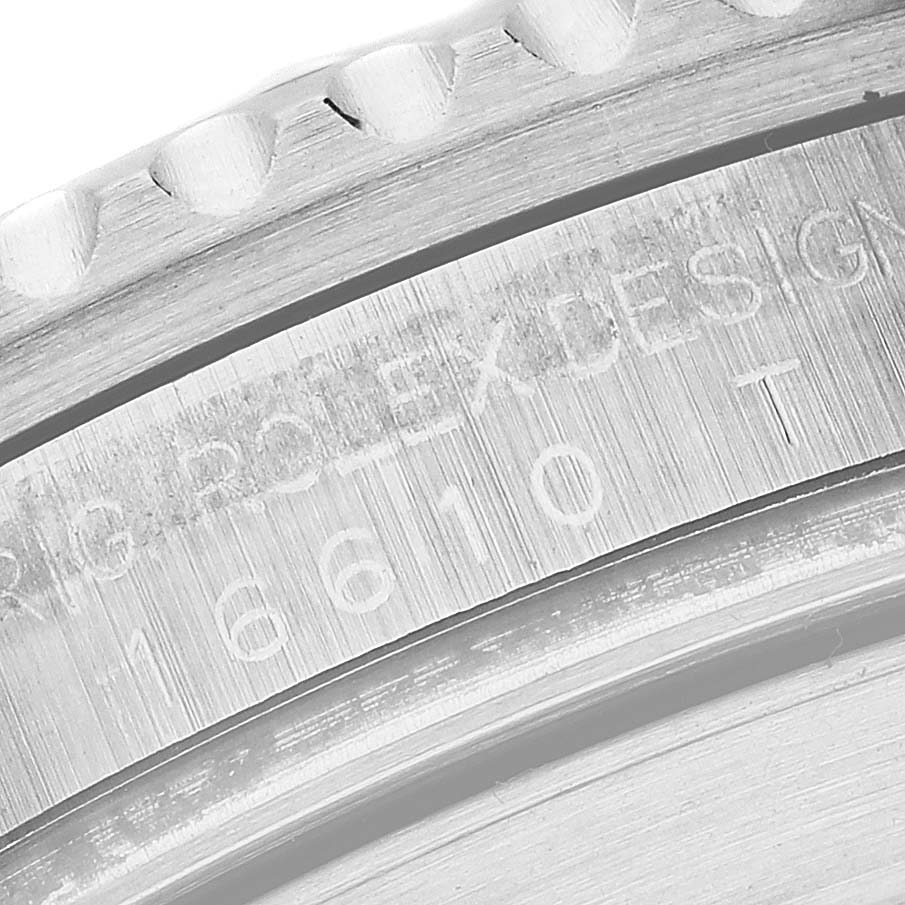 The image shows a close-up of the engraved details on the side of the bezel of a Rolex Submariner 16610 Men
s Stainless Steel Black Dial 16610 Men
s Stainless Steel Black Dial watch.
