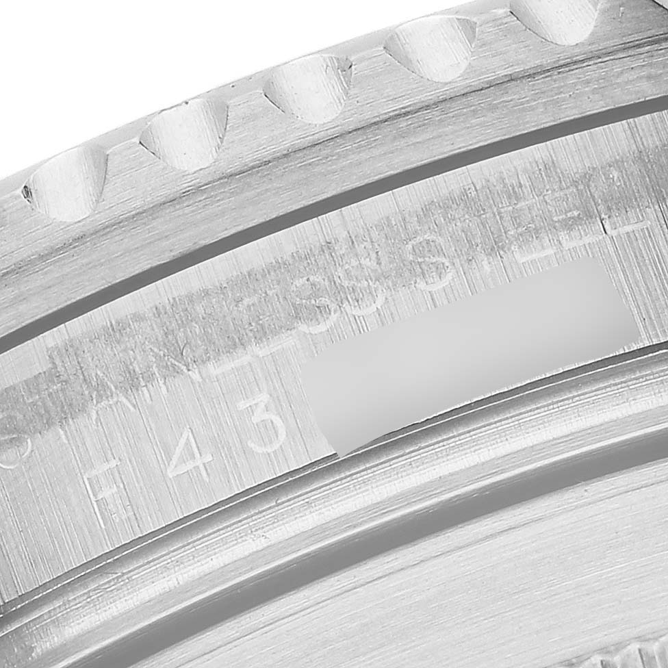 This image shows a close-up of the bezel and engraving on a Rolex Submariner 16610 Men
s Stainless Steel Black Dial 16610 Men
s Stainless Steel Black Dial
s case.