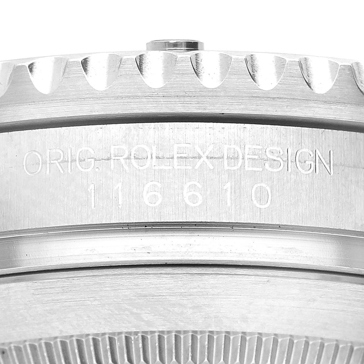 This image shows a close-up of the side of the bezel and case of a Rolex Submariner 116610LV Men's Stainless Steel Green Dial 116610LV Men's Stainless Steel Green Dial, displaying "ORIG. ROLEX DESIGN" and the model number.