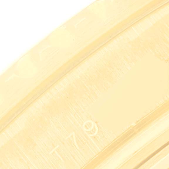 This close-up image shows a portion of the bezel on a Rolex Yacht-Master 69628 Women's Yellow Gold White Dial 69628 Women's Yellow Gold White Dial watch.