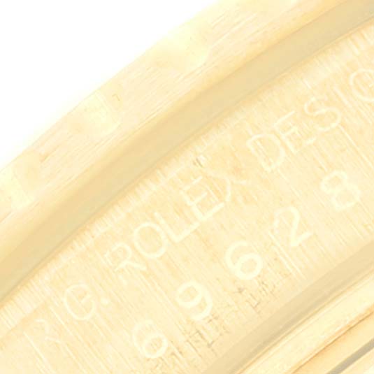 The image shows a close-up angle of the inner bezel with the engraving on a Rolex Yacht-Master 69628 Women's Yellow Gold White Dial 69628 Women's Yellow Gold White Dial model.