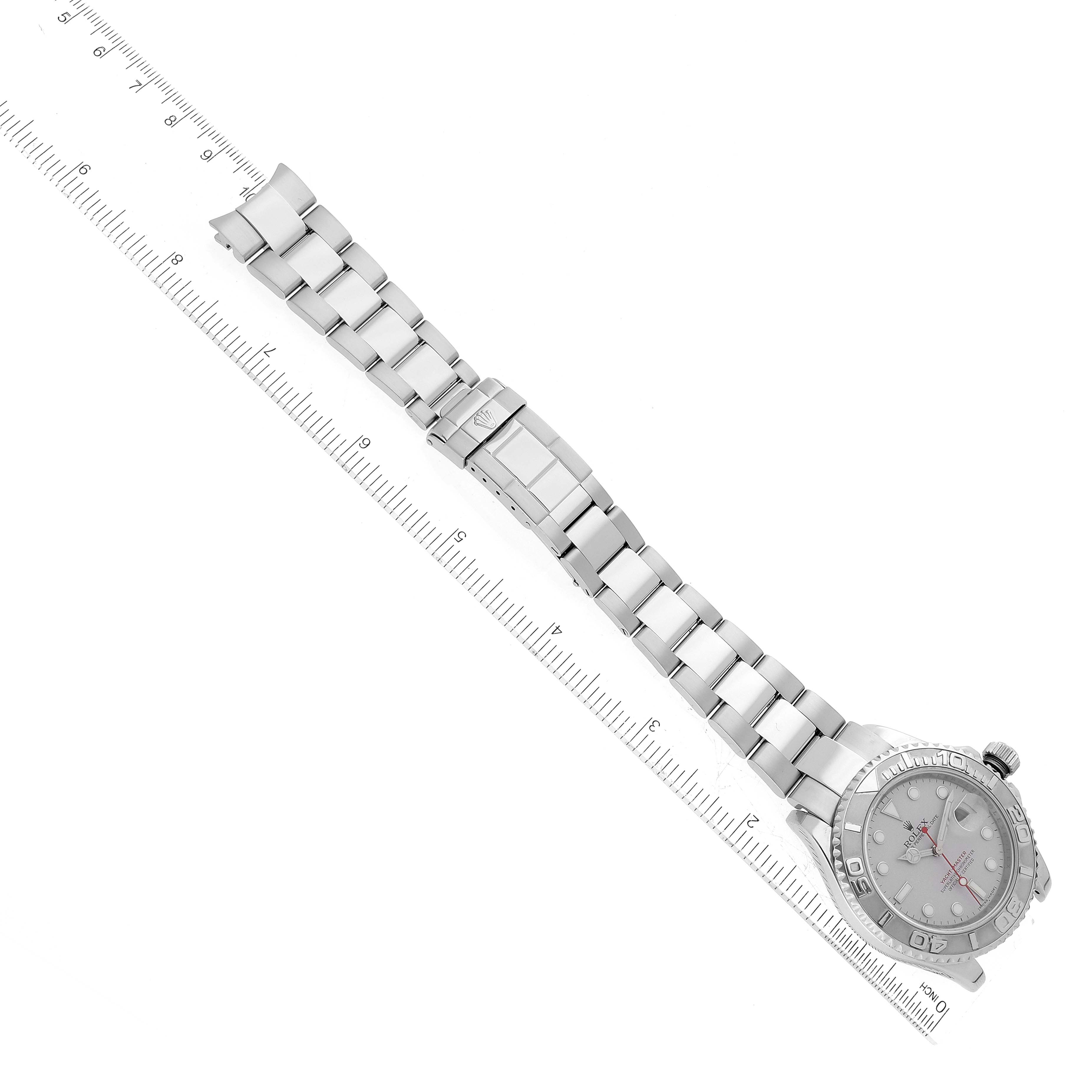 The image shows a top view of a Rolex Yacht-Master 16622 Men's Stainless Steel Silver Dial 16622 Men's Stainless Steel Silver Dial watch, highlighting its bracelet and partial dial alongside a ruler.