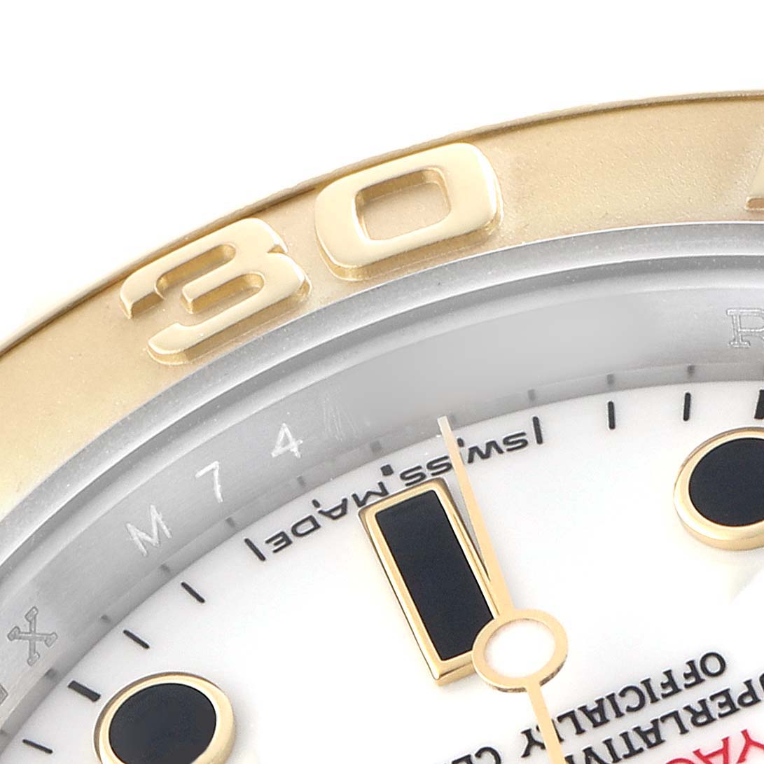 The image shows a close-up of the Rolex Yacht-Master 16623 Men's Steel and Gold (two tone) White Dial watch, highlighting the gold bezel, part of the dial, and markers.