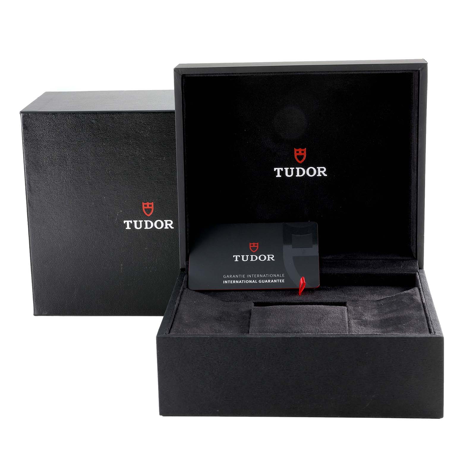 The image shows the packaging and guarantee card for a Tudor Heritage Black Bay M79470 Men
s Stainless Steel Black Dial M79470 Men
s Stainless Steel Black Dial watch, with the box open.