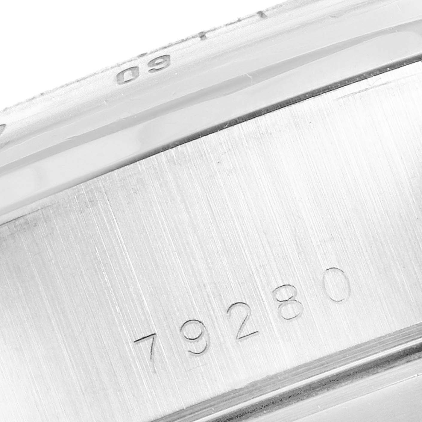 The image shows a close-up of the case side of a Tudor Prince 79280 Men
s Stainless Steel Black Dial 79280 Men
s Stainless Steel Black Dial model watch, highlighting the serial number engraving.