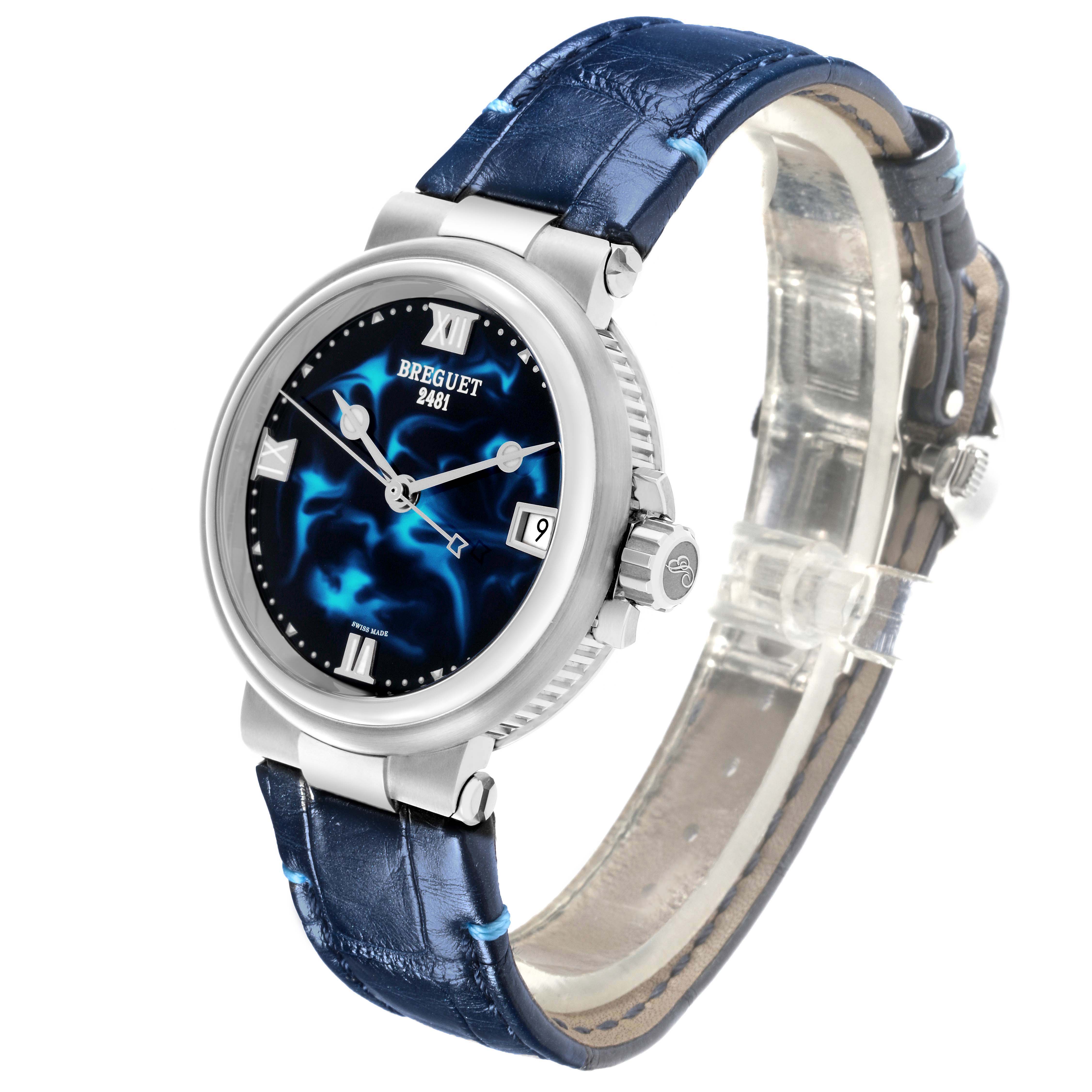 The Breguet Marine 9517ST/E2/984 Men's Stainless Steel Blue Dial watch is shown at a three-quarter angle, displaying the dial, bezel, crown, and part of the blue strap.