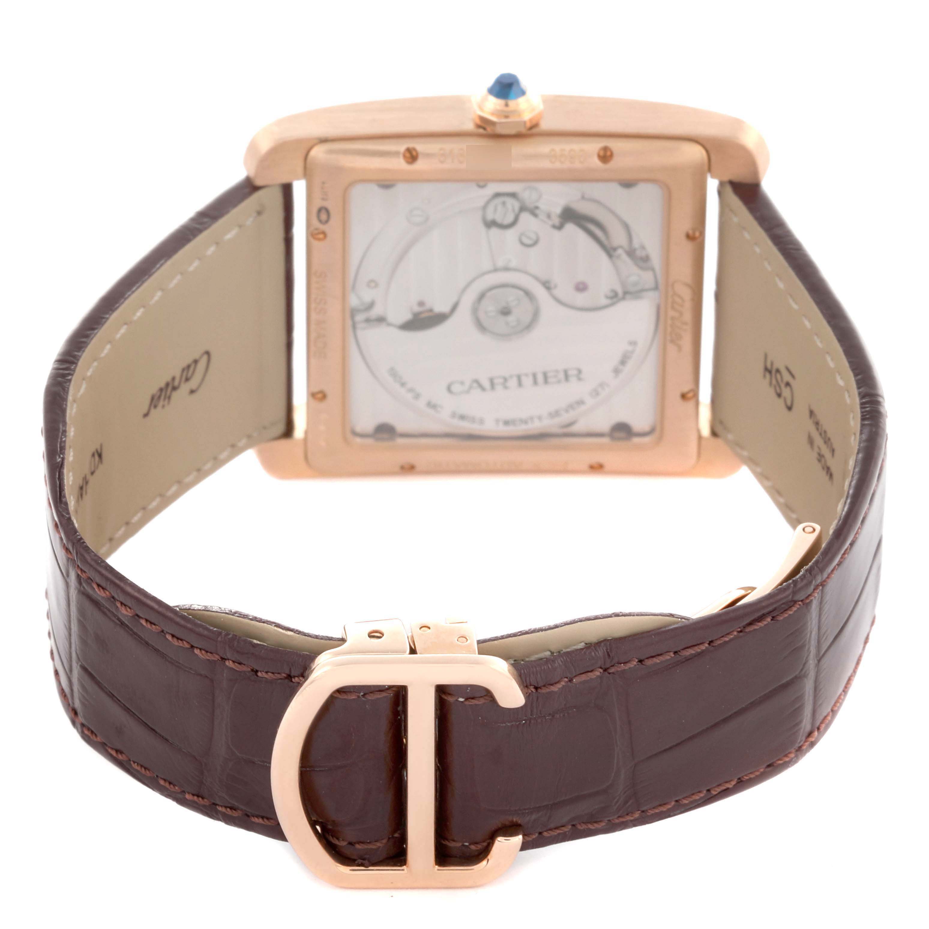 The image shows the back view of a Cartier Tank MC W5330002 Men's Rose Gold Brown Dial watch, highlighting the movement through the transparent case back and the leather strap.