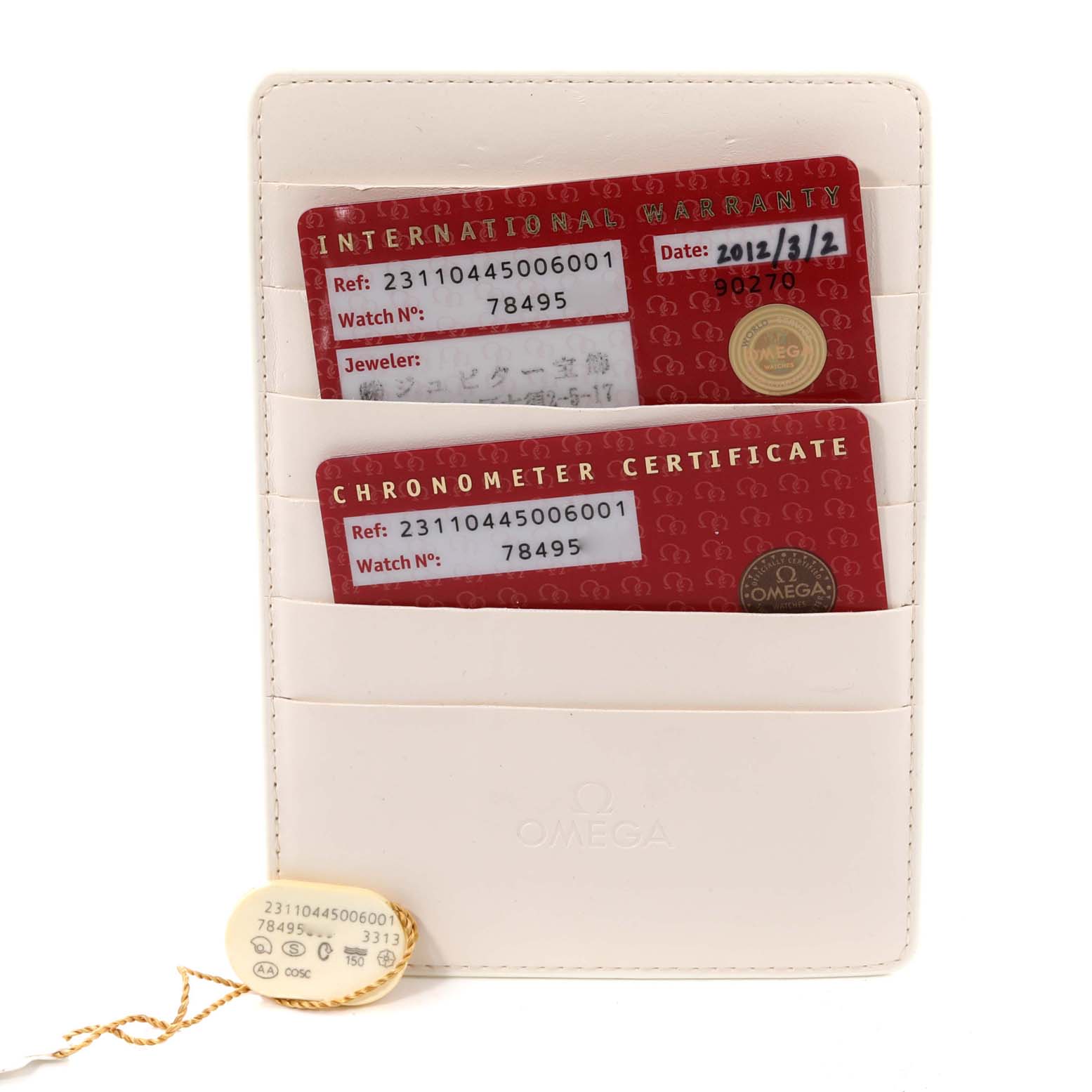 This image shows the warranty and chronometer certificate cards for the Omega Aqua Terra 231.10.44.50.06.001 Men
s Stainless Steel Grey Dial 231.10.44.50.06.001 Men
s Stainless Steel Grey Dial watch, along with its tag, in a white holder.