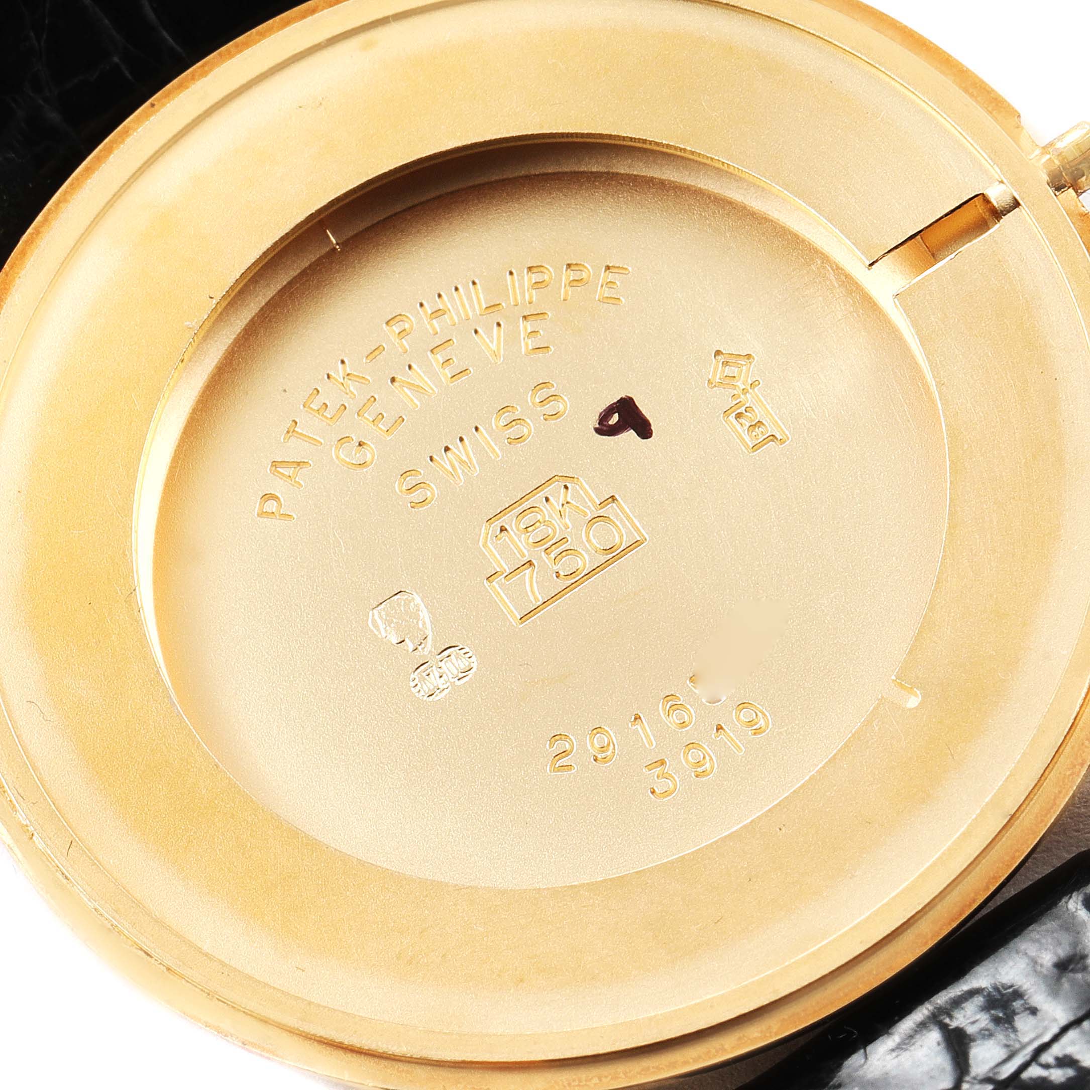 The image shows the inside case back of a Patek Philippe Calatrava 3919 Men's Yellow Gold White Dial 3919 Men's Yellow Gold White Dial watch, highlighting engravings and hallmarks.