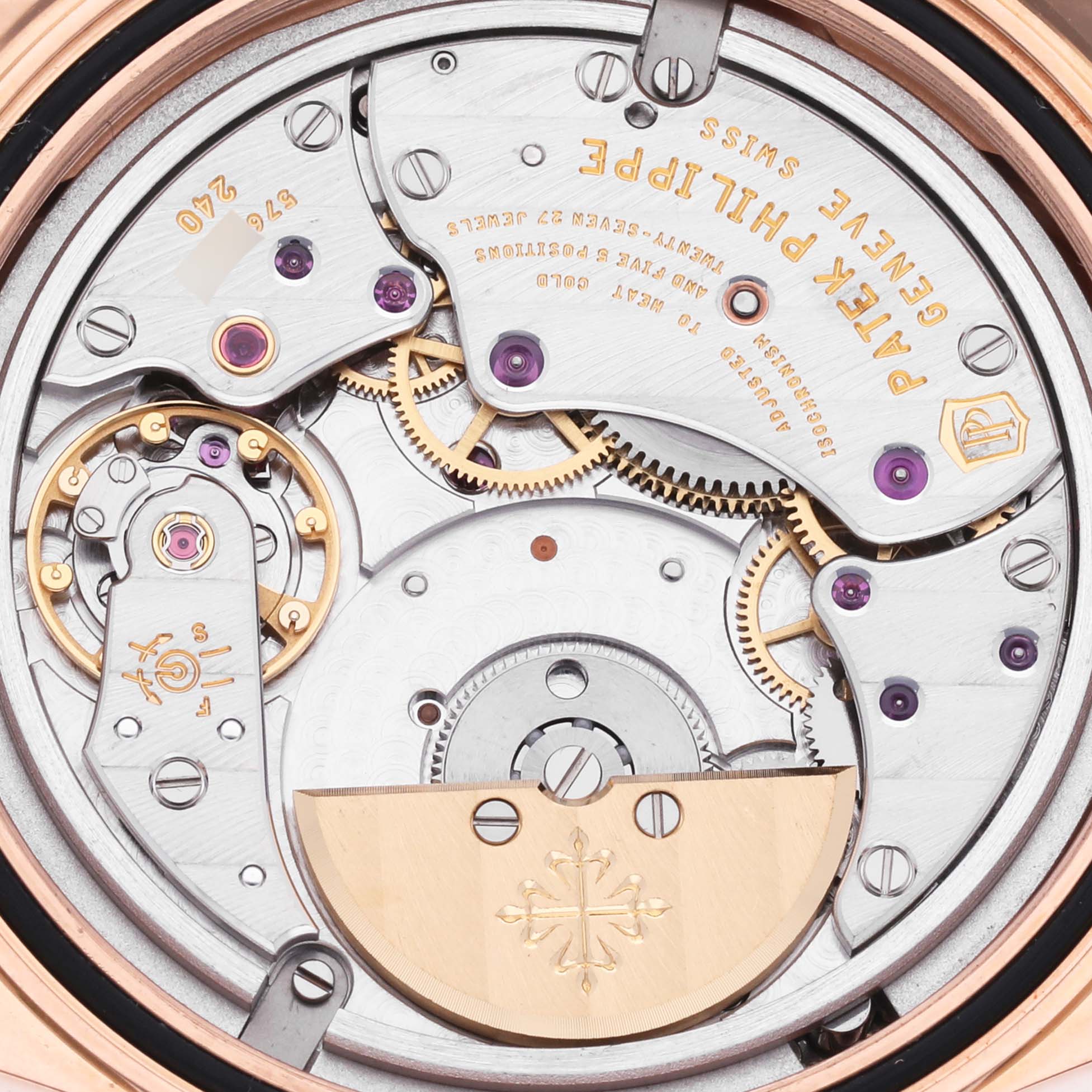 The image shows the intricate movement and gears of the Patek Philippe Calatrava 6000R-001 Men's Rose Gold Brown Dial 6000R-001 Men's Rose Gold Brown Dial watch from a back angle.