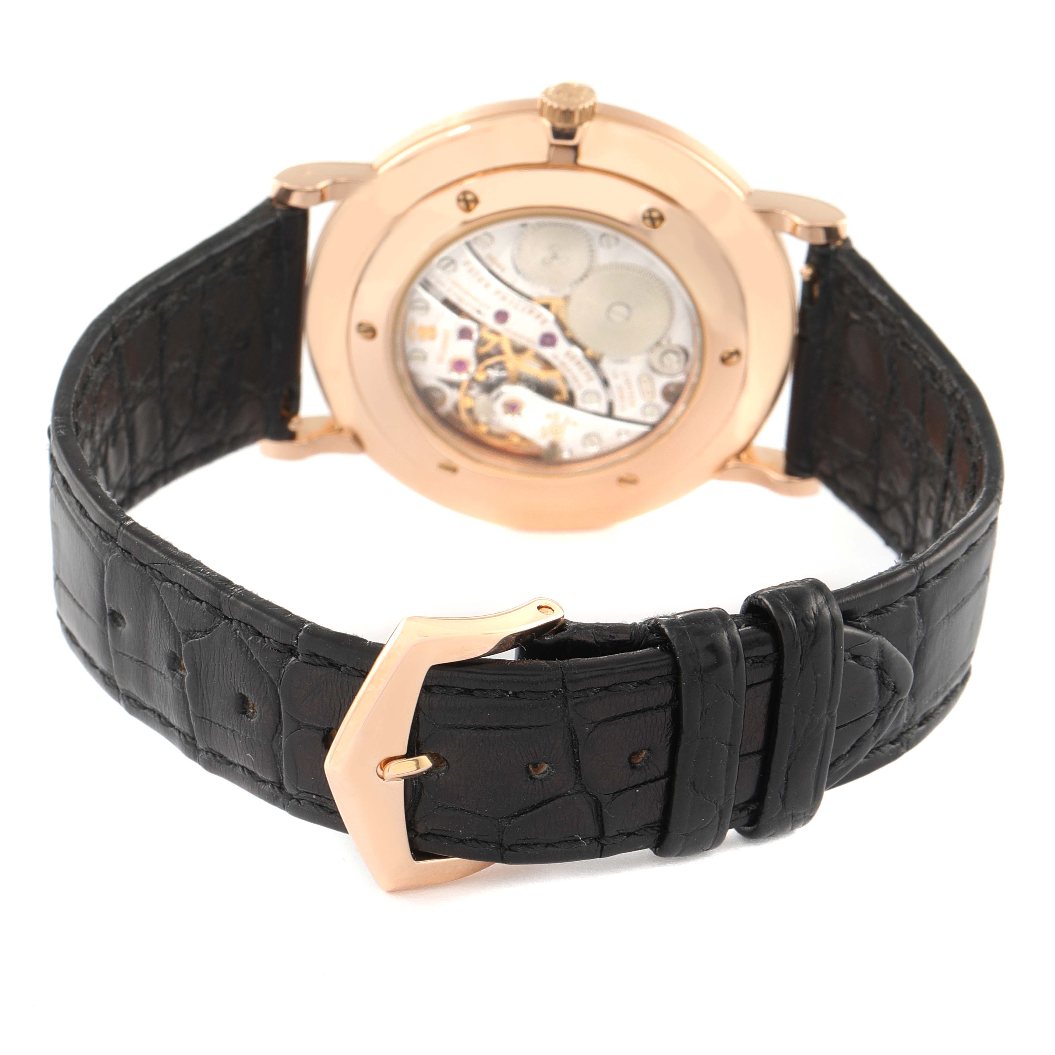 The image shows the back view of the Patek Philippe Calatrava 5119R Men's Rose Gold White Dial 5119R Men's Rose Gold White Dial watch, highlighting its black leather strap and exposed movement.