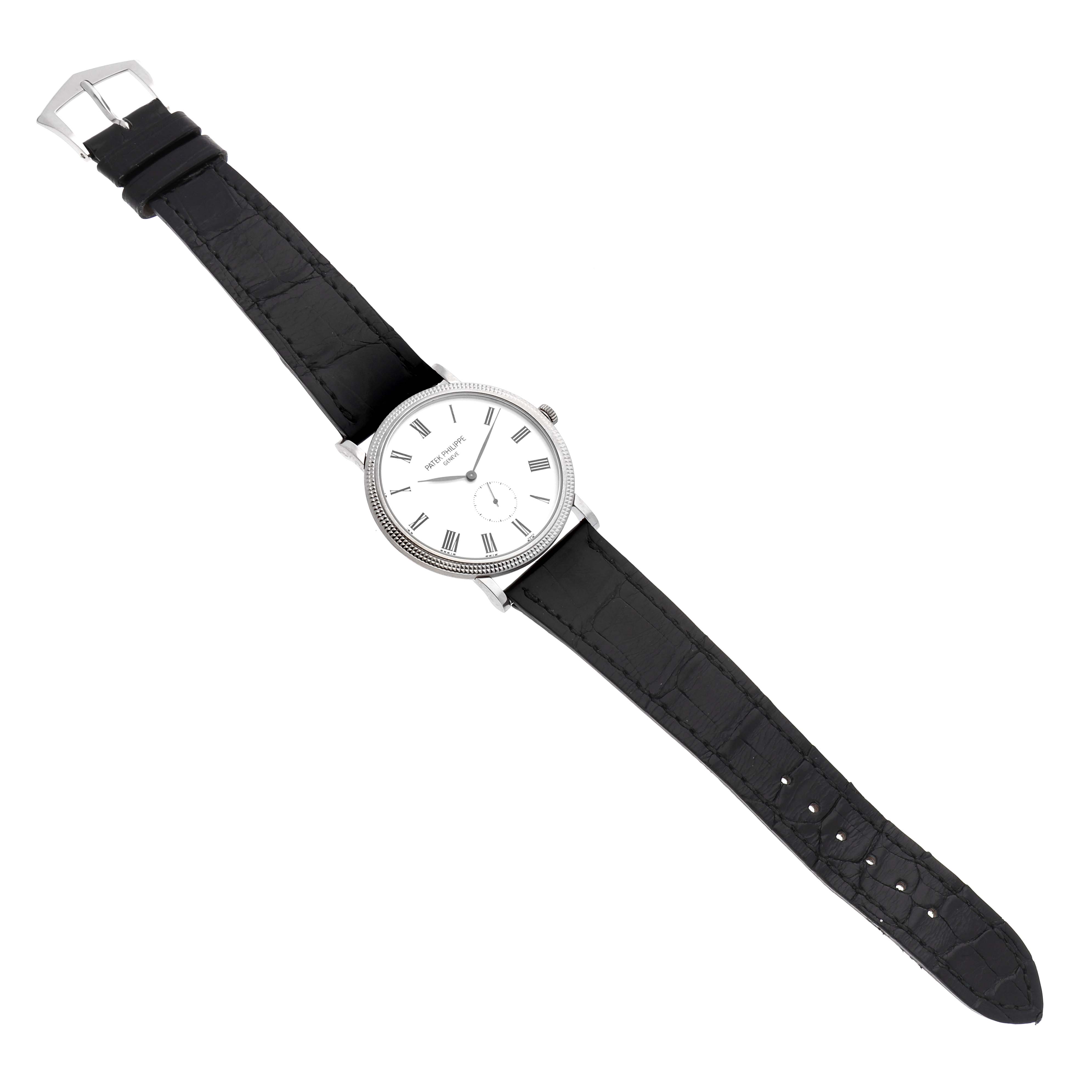 The Patek Philippe Calatrava 5119G Men's White Gold White Dial watch is shown at an overhead angle, displaying the face, case, and leather strap.