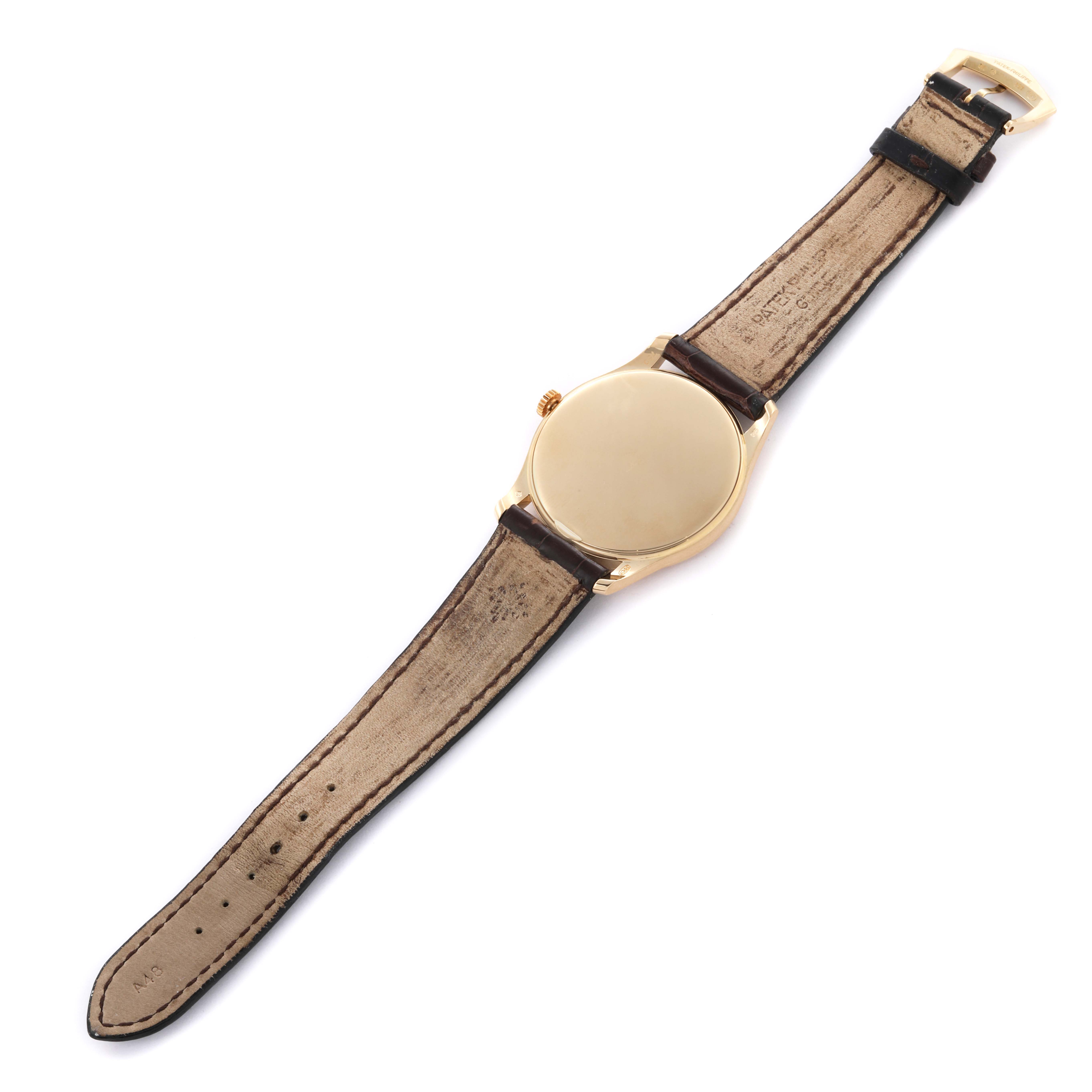 The image shows the back of a Patek Philippe Calatrava 5196J-001 Men's Yellow Gold Silver Dial 5196J-001 Men's Yellow Gold Silver Dial watch, displaying its case and strap laid flat.