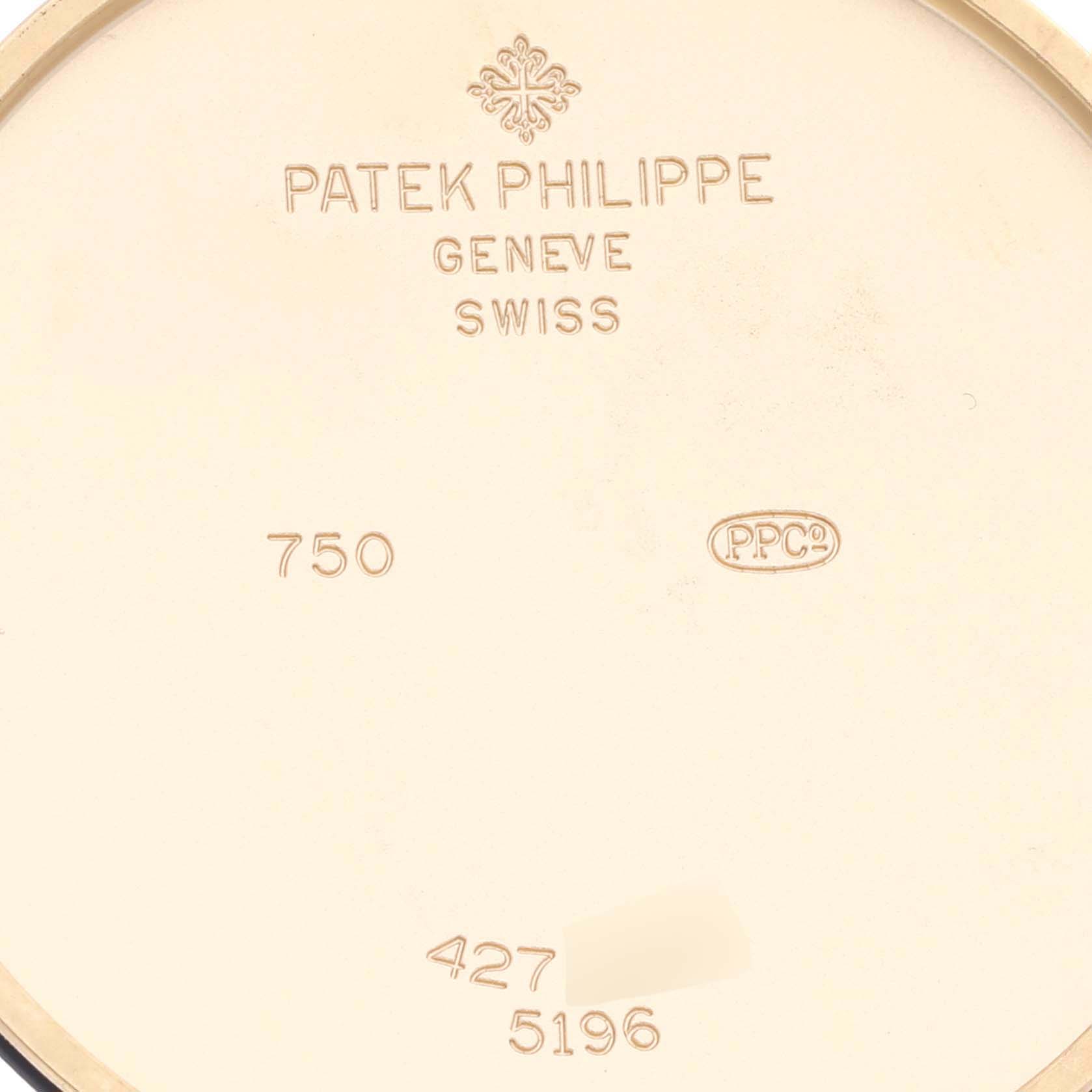 The image shows the inner case back of a Patek Philippe Calatrava 5196J-001 Men's Yellow Gold Silver Dial 5196J-001 Men's Yellow Gold Silver Dial, displaying engravings and markings.