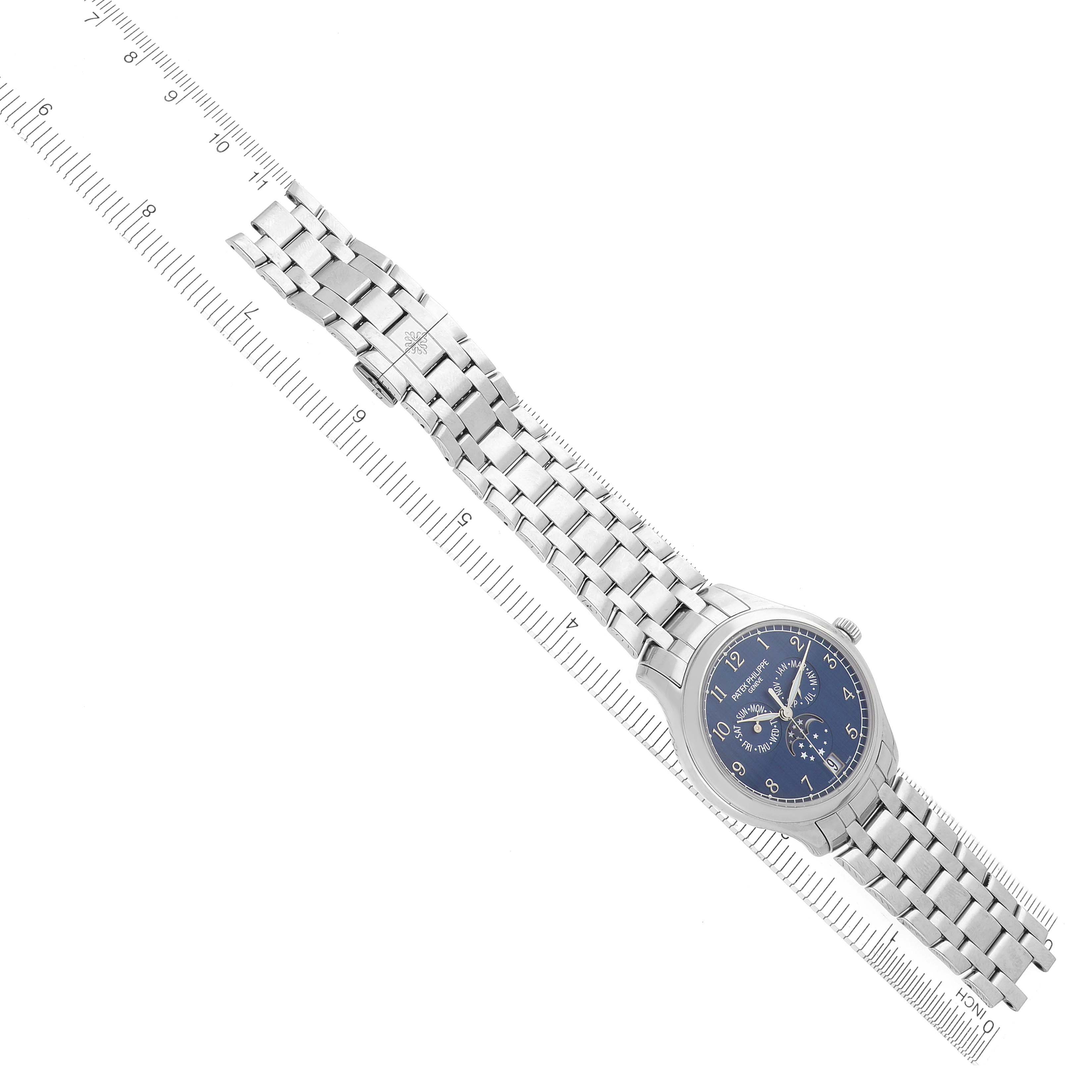 The Patek Philippe Complications 4947/1A-001 Men's Stainless Steel Blue Dial 4947/1A-001 Men's Stainless Steel Blue Dial watch is shown from a top-down angle, highlighting the dial, crown, and full metal bracelet.