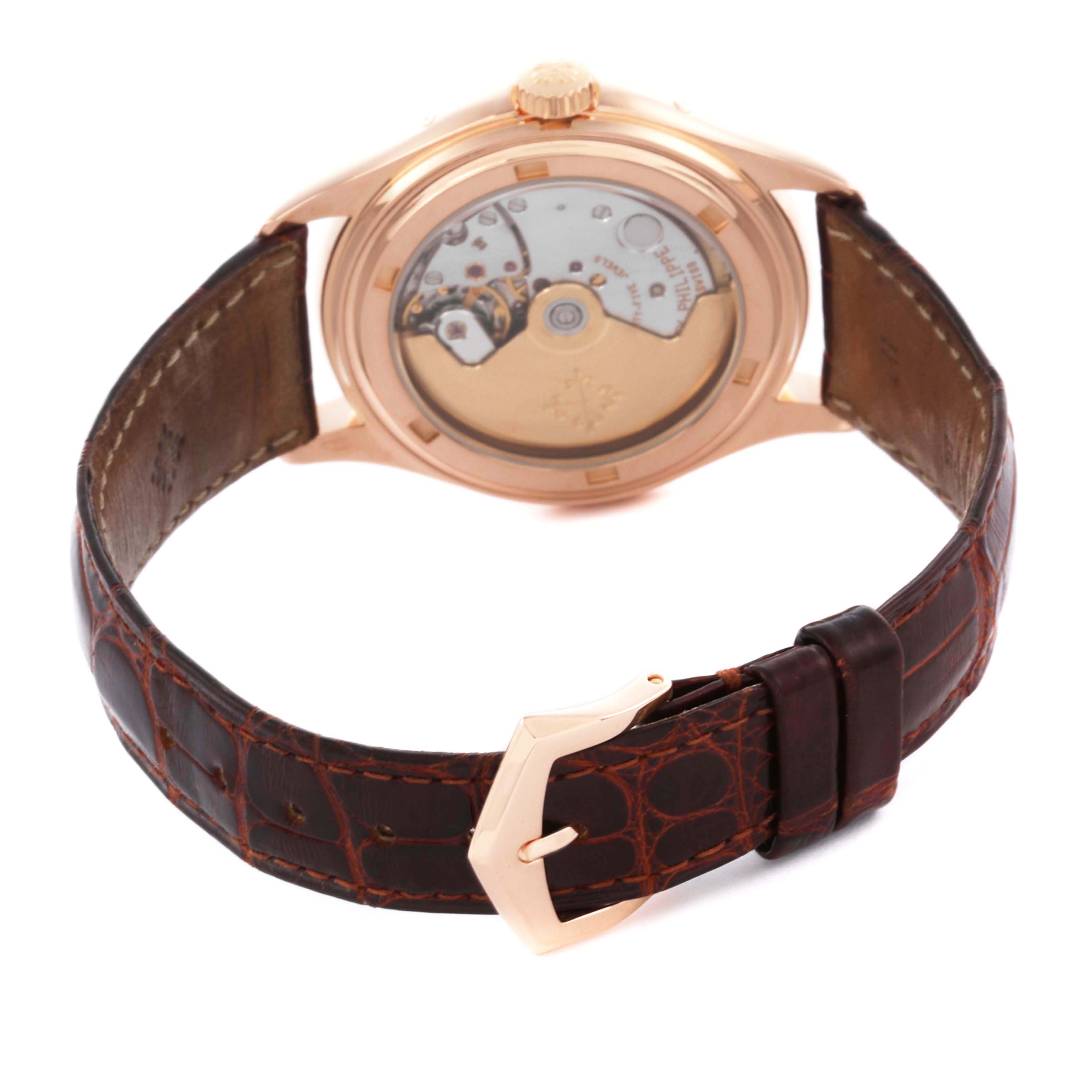 The image shows the back view of the Patek Philippe Complications 5035R-001 Men
s Rose Gold Silver Dial 5035R-001 Men
s Rose Gold Silver Dial watch, highlighting its leather strap and transparent case back.