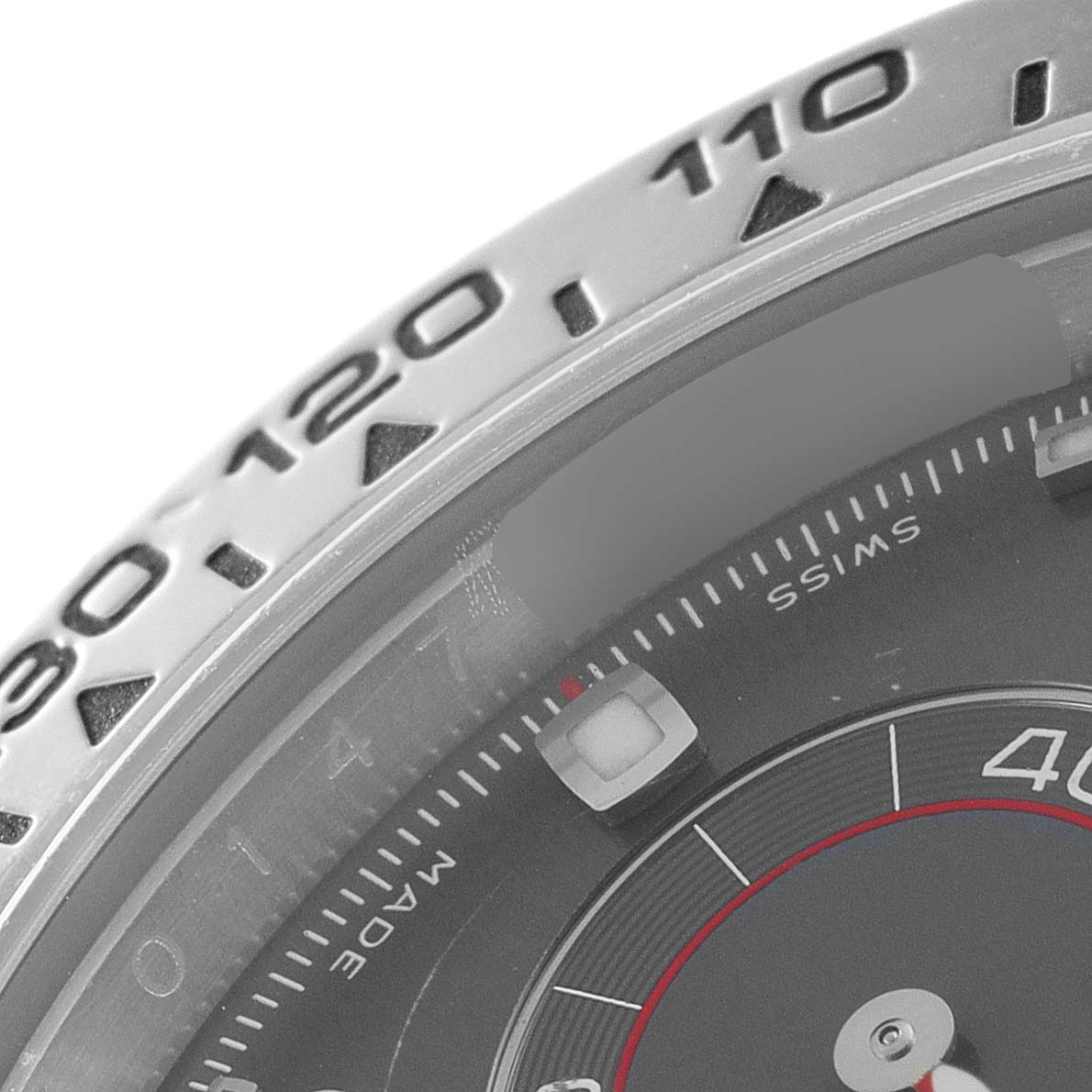 The image shows a close-up of the bezel and part of the dial of a Rolex Daytona 116509 Men's White Gold Grey Dial 116509 Men's White Gold Grey Dial watch.