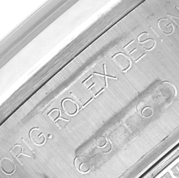 The image shows a close-up of the engraving on the side of a Rolex Date 69160 Women
s Stainless Steel White Dial 69160 Women
s Stainless Steel White Dial watch case.