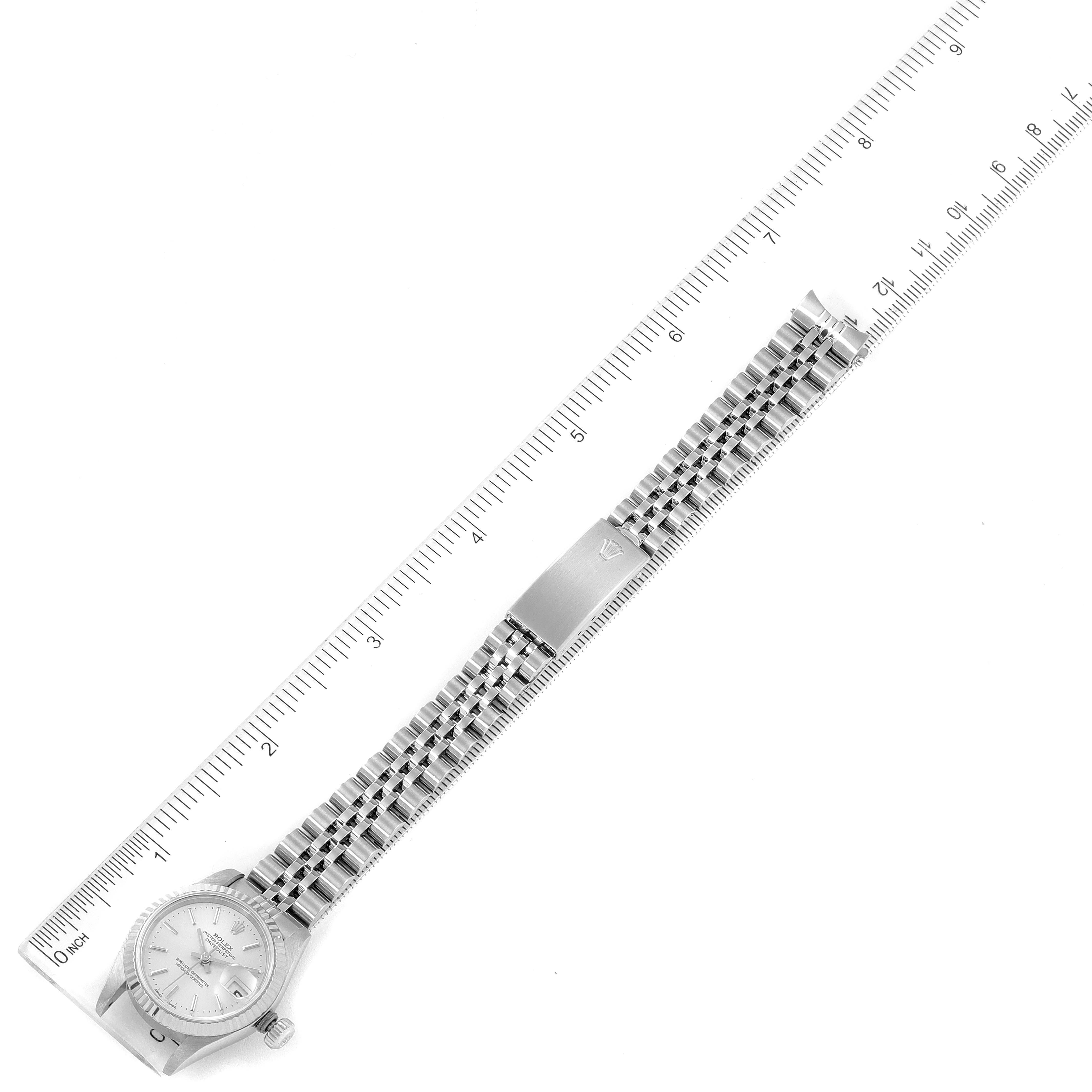 The image shows a Rolex Datejust 79174 Women
s Stainless Steel Silver Dial 79174 Women
s Stainless Steel Silver Dial watch laid flat, with a ruler indicating length, displaying the face, bracelet, and clasp.