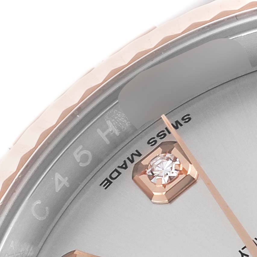 The image shows a close-up of the bezel and part of the dial of a Rolex Datejust 116231 Men's Steel and Gold (two tone) Silver Dial 116231 Men's Steel and Gold (two tone) Silver Dial, featuring a diamond hour marker.