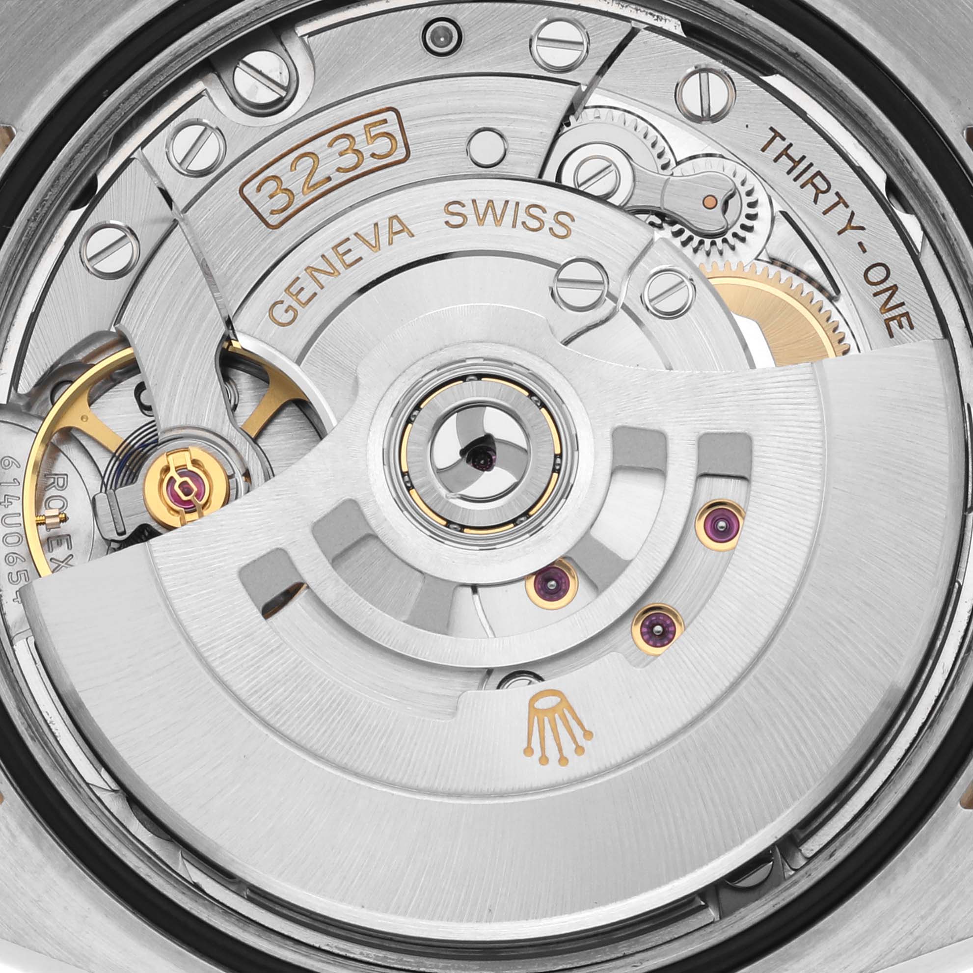 The image shows a close-up of the Rolex Datejust 126283RBR Men's Steel and Gold (two tone) Champagne Dial 126283RBR Men's Steel and Gold (two tone) Champagne Dial movement, highlighting the rotor and intricate components.
